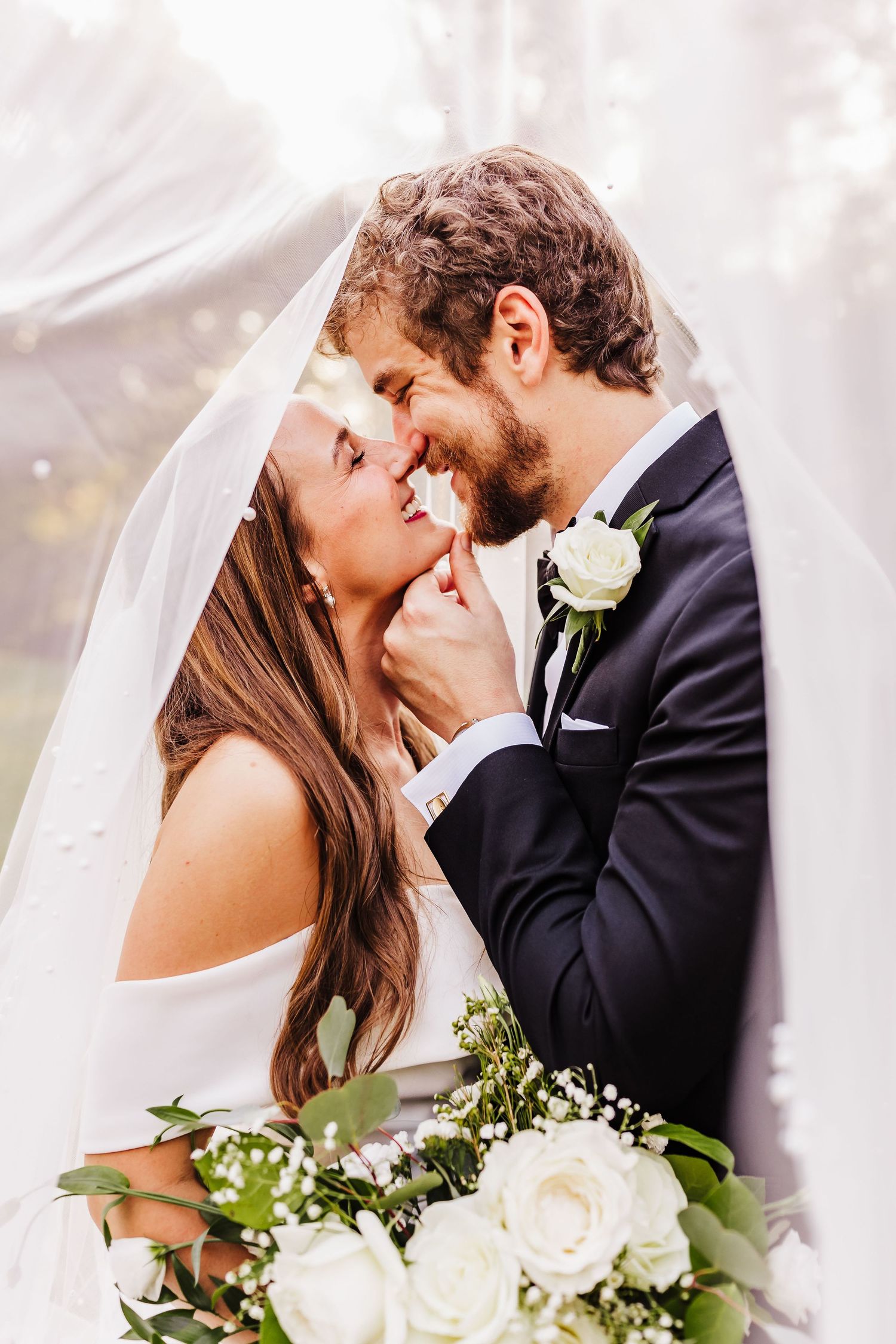 Bride and groom sharing an intimate moment beneath the veil during a North Georgia wedding portrait.