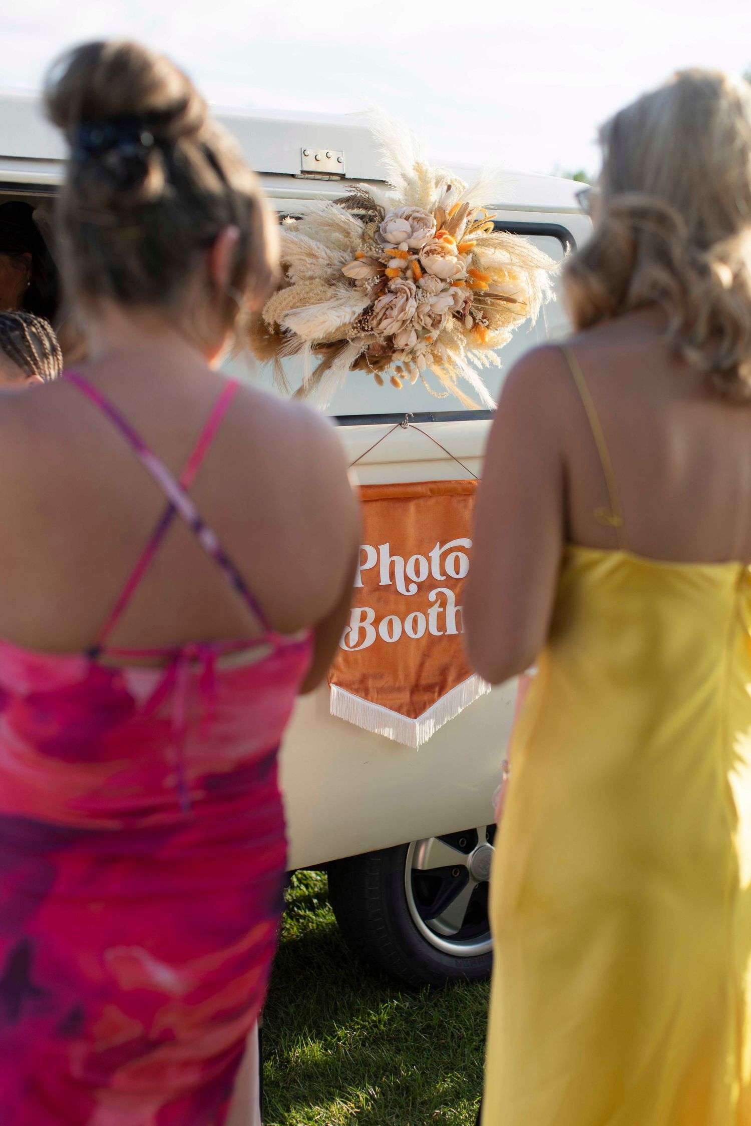 Two woman waiting in line for Photo Booth at wedding