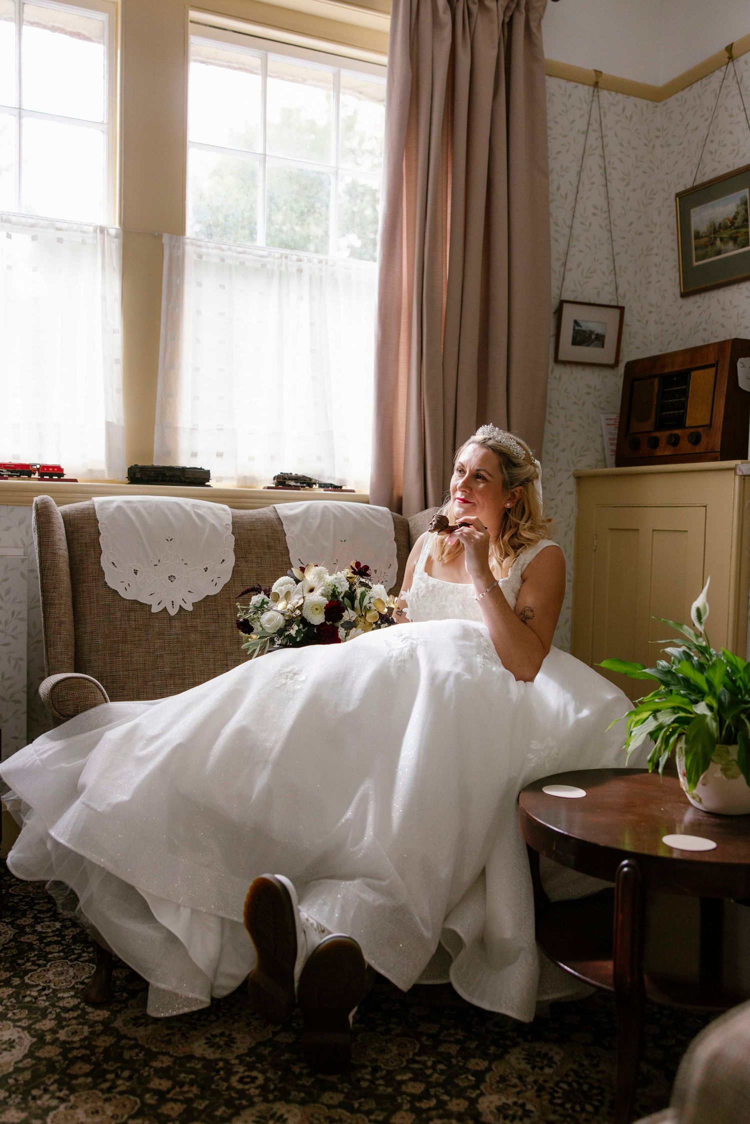 bride smoking a pipe in the lounge waiting for her train to arrive at the platform, Swanage railway.