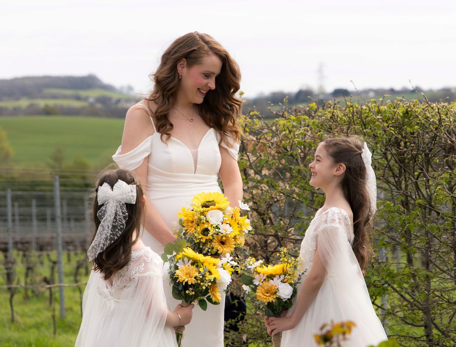 Bride looking at her two daughters as they are about to walk down the isle