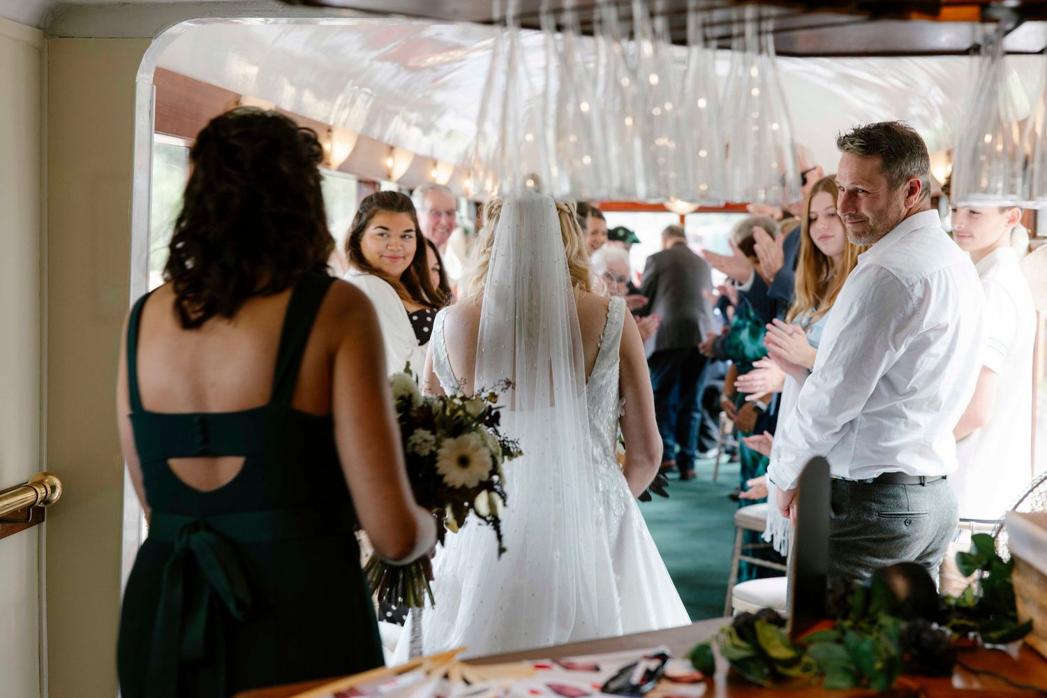 Bride walking down the aisle inside the pullman carriage