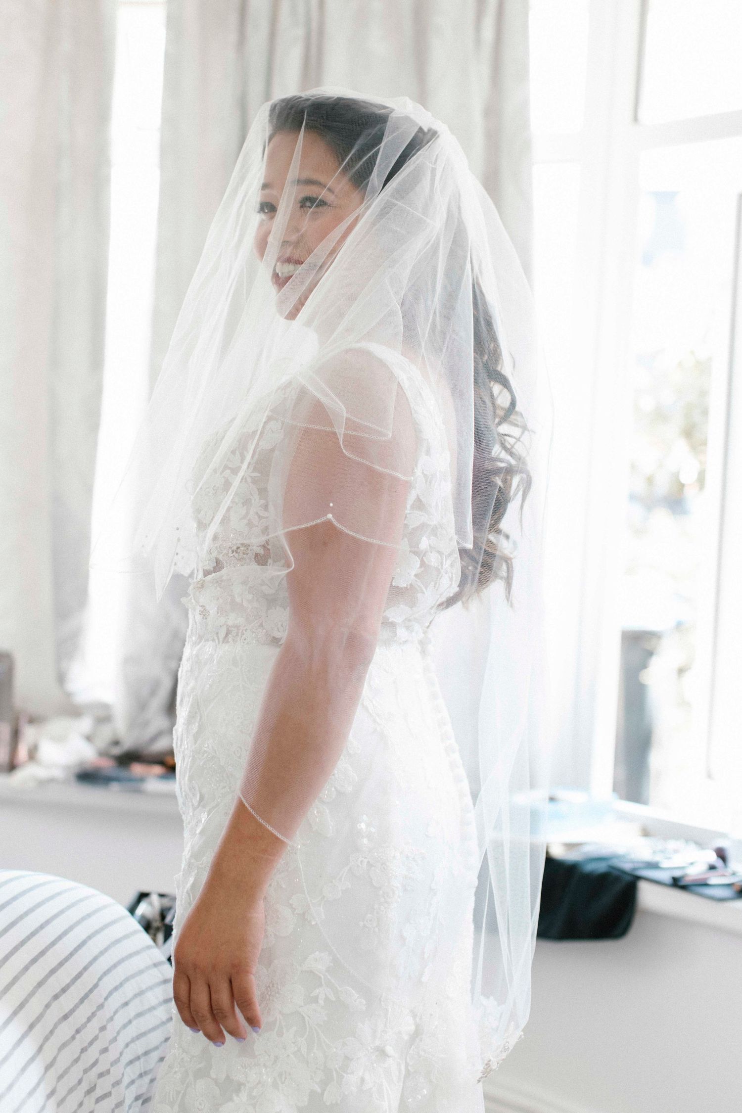 Bridal portrait as she puts her vail on to go and get married