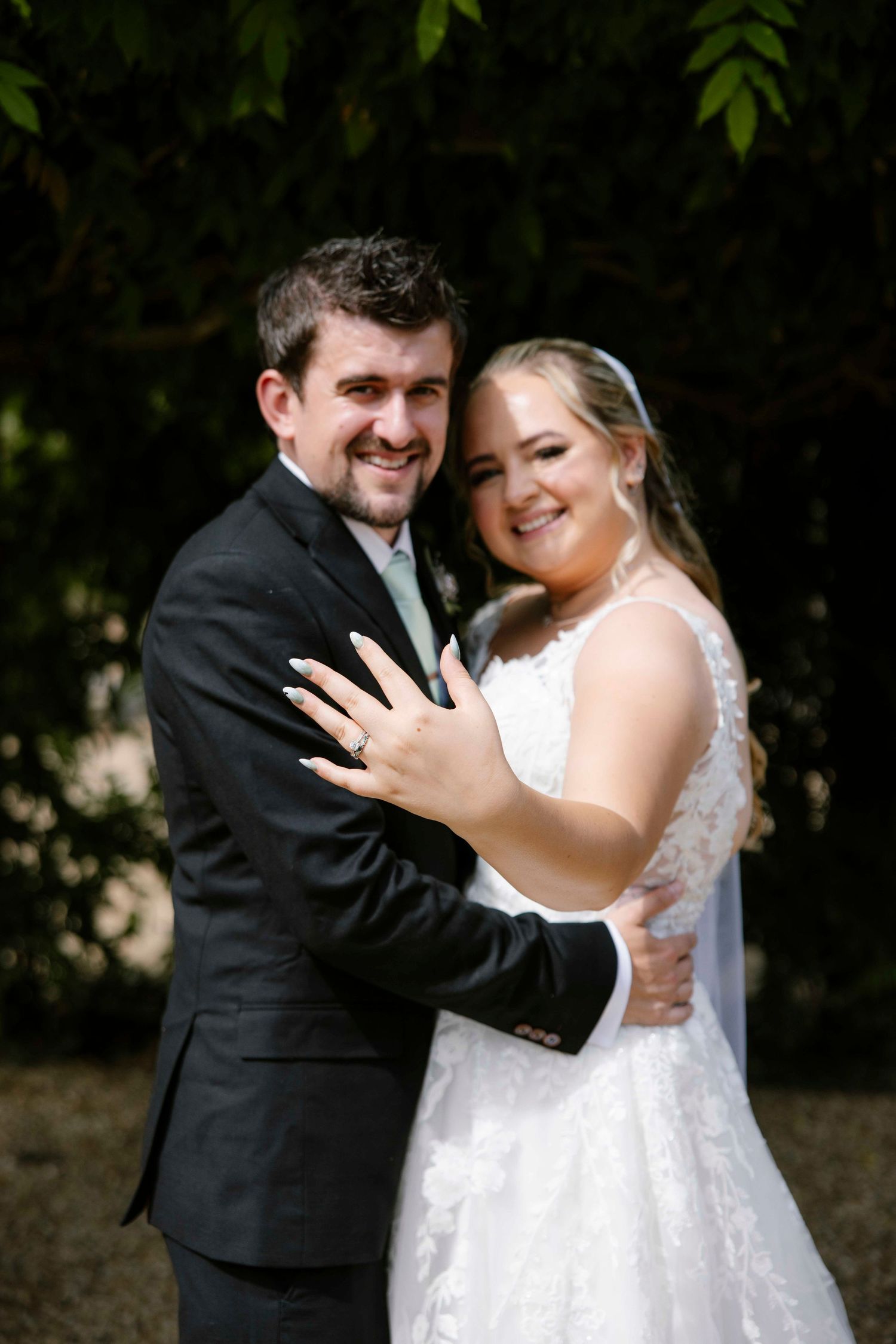 Wife holding her hand out, showing off the ring as they got married