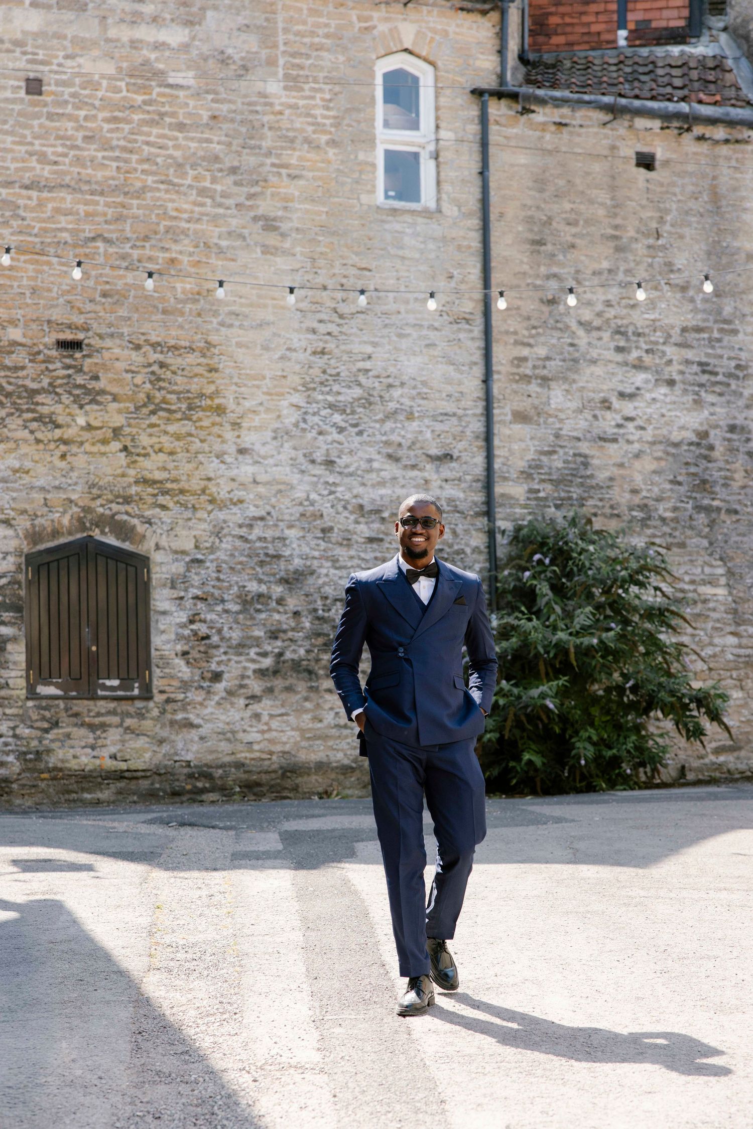 Groom arriving at the wedding walking down the hill at Silk mill Frome