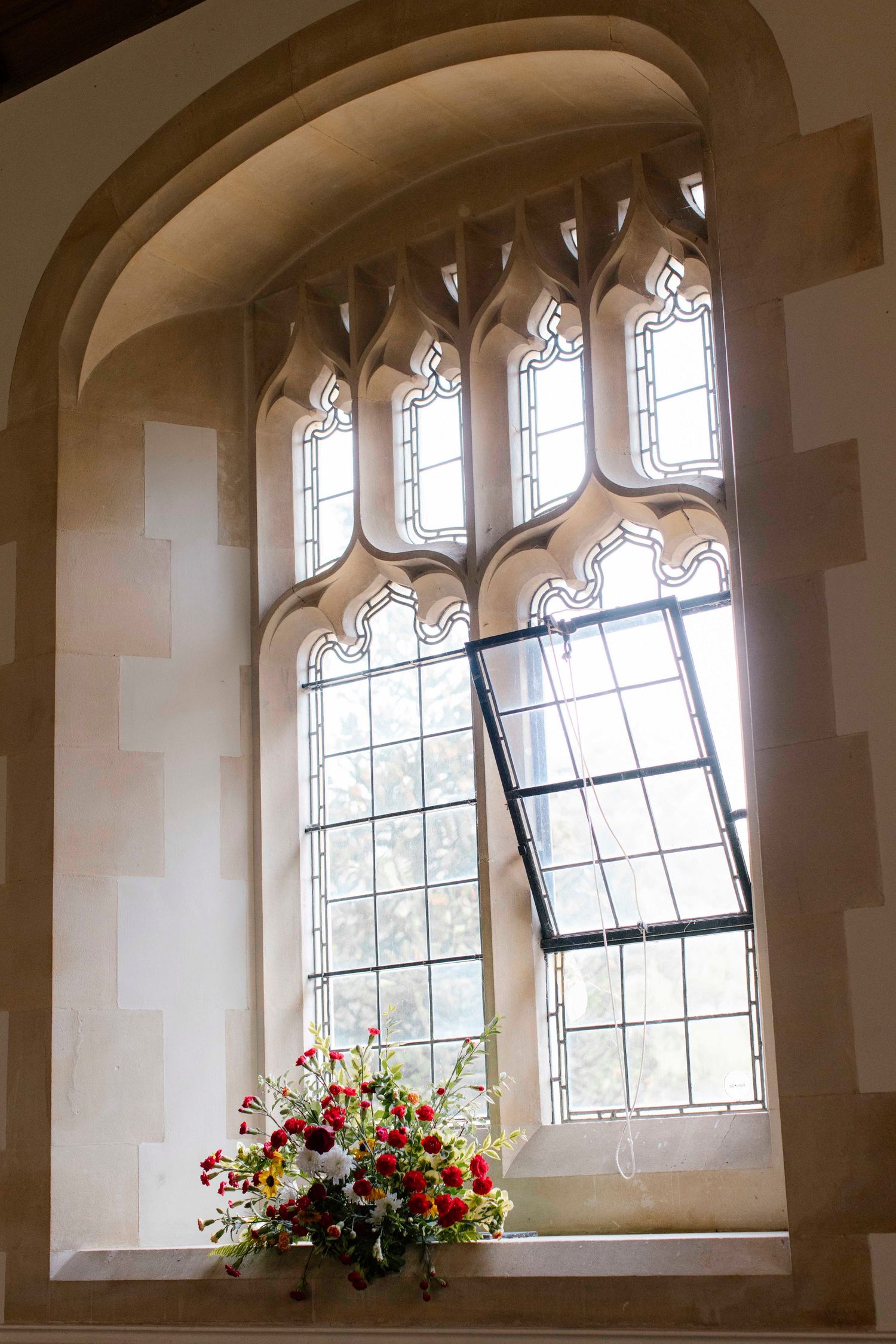 St Stephen's, Kingston, light shinning through the window on to the flower decor of the wedding