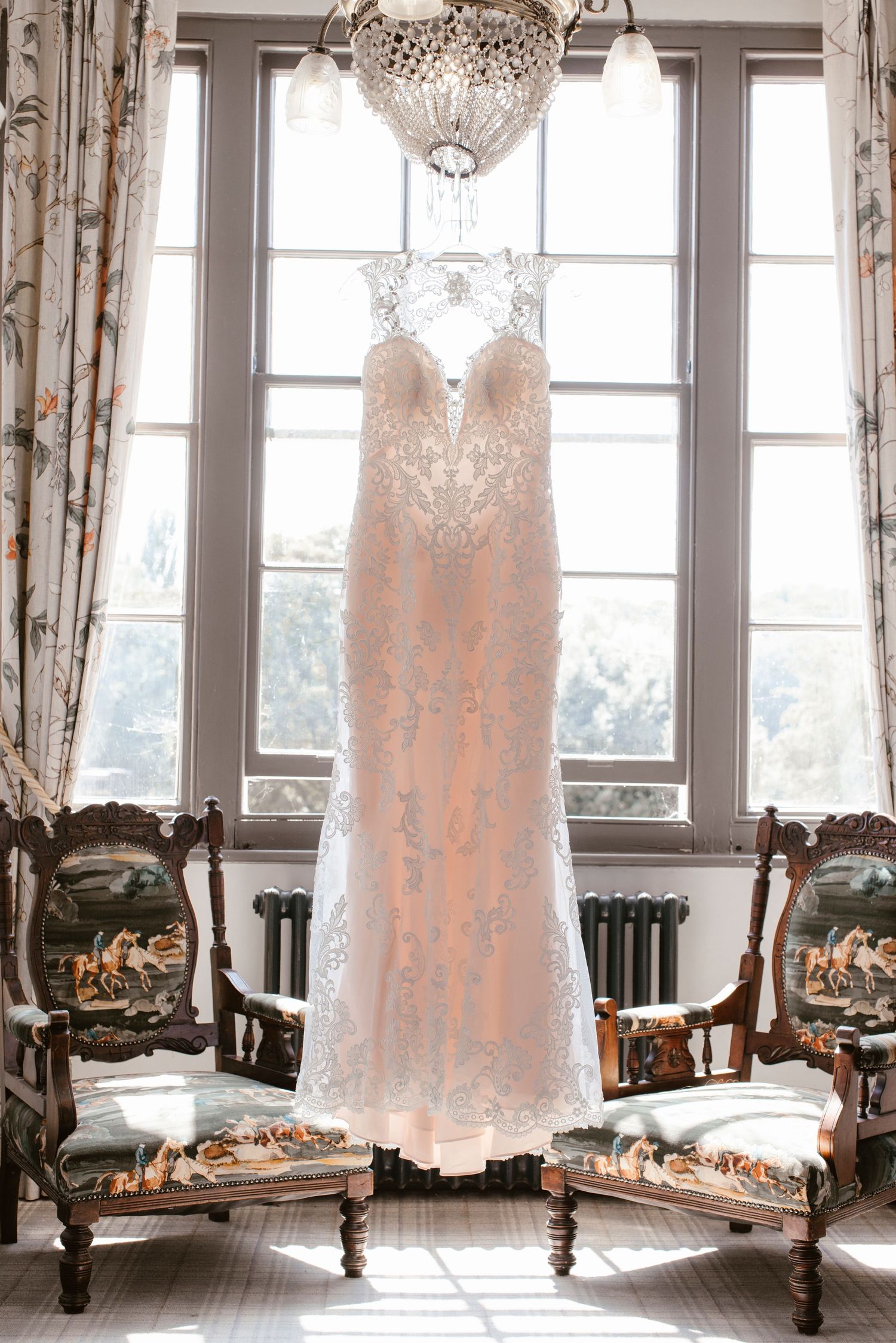 Pink and lace dress hanging from window