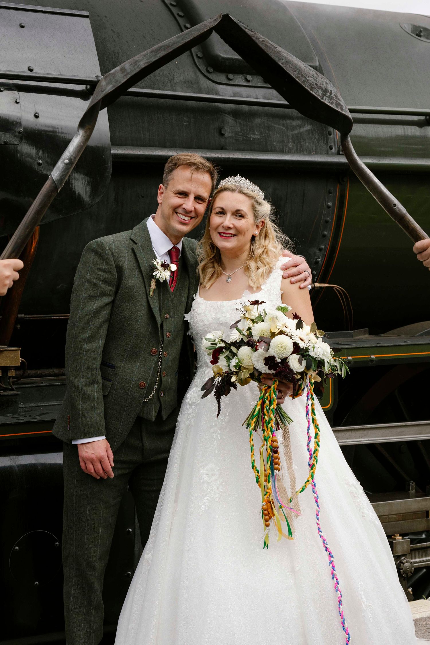 Husband and Wife under two shovels used for the coal infant of steam train