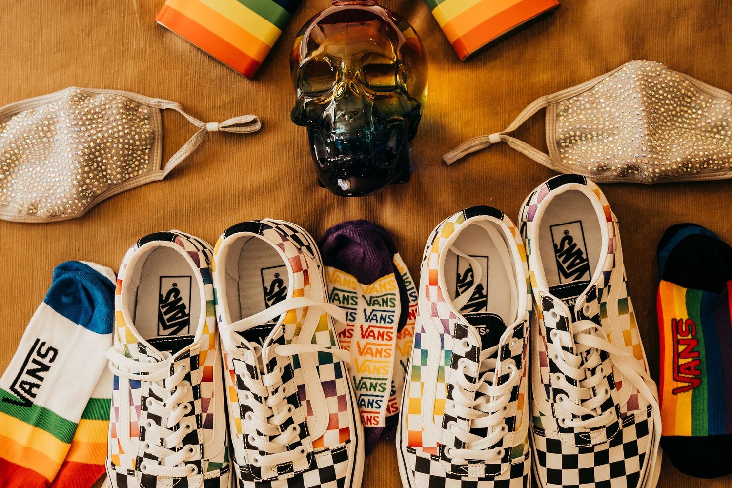 Vans Pride collection featuring checkered sneakers, rainbow socks, and crystal skull display.