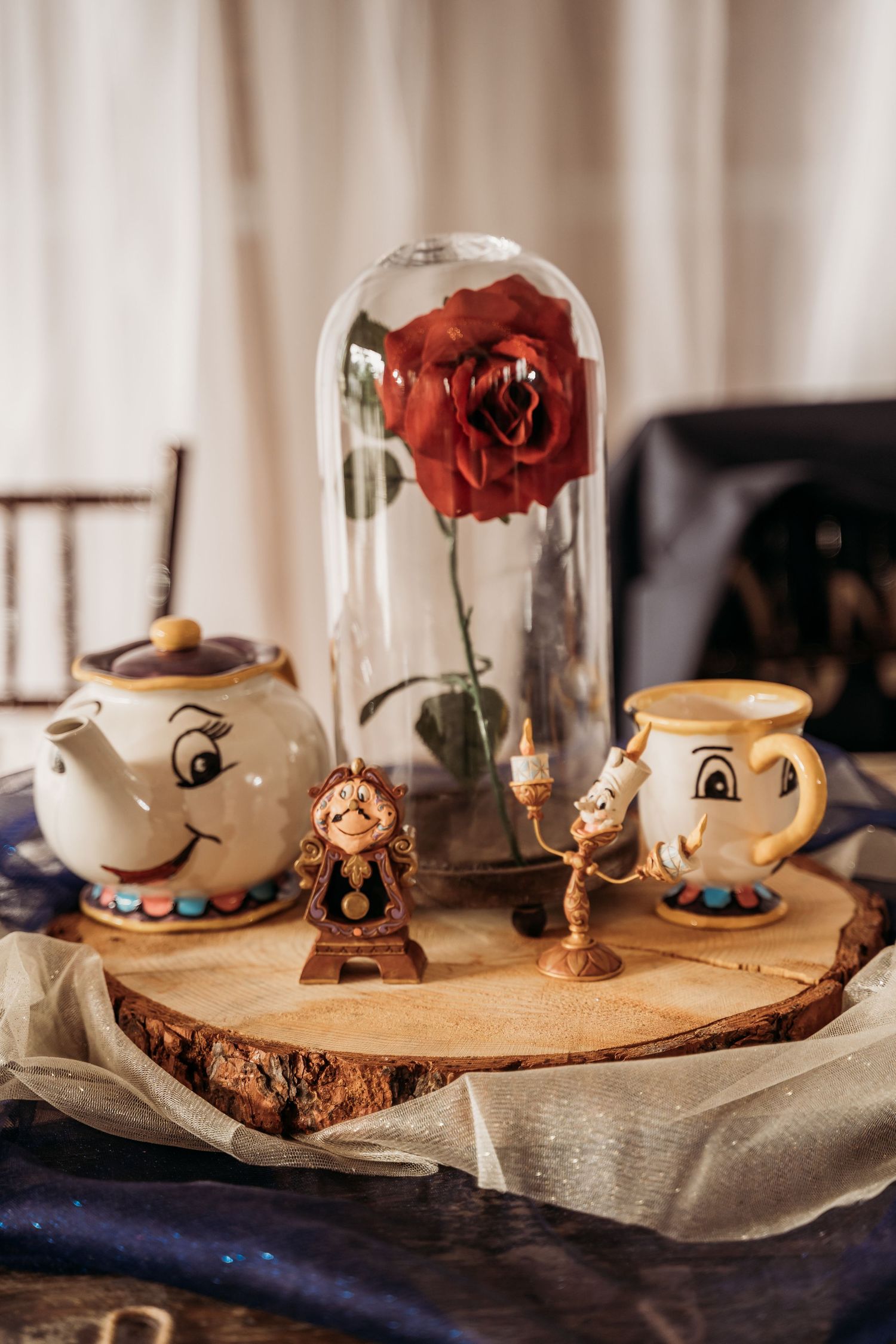 Beauty and the Beast wedding centerpiece with Mrs. Potts, Chip, Cogsworth, and enchanted rose.