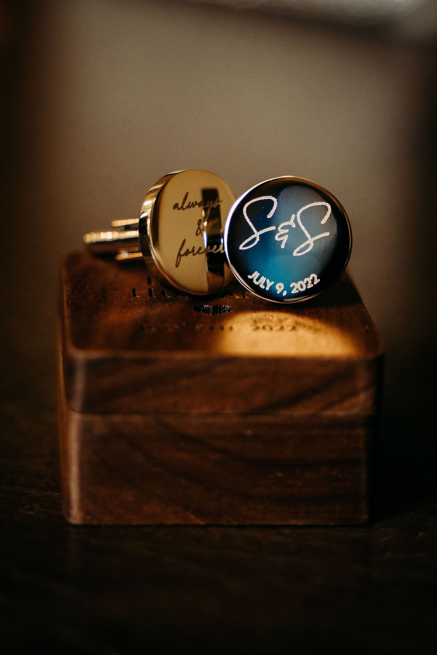 Custom wedding cufflinks engraved with S&S initials and July 9, 2022 date on wooden box.