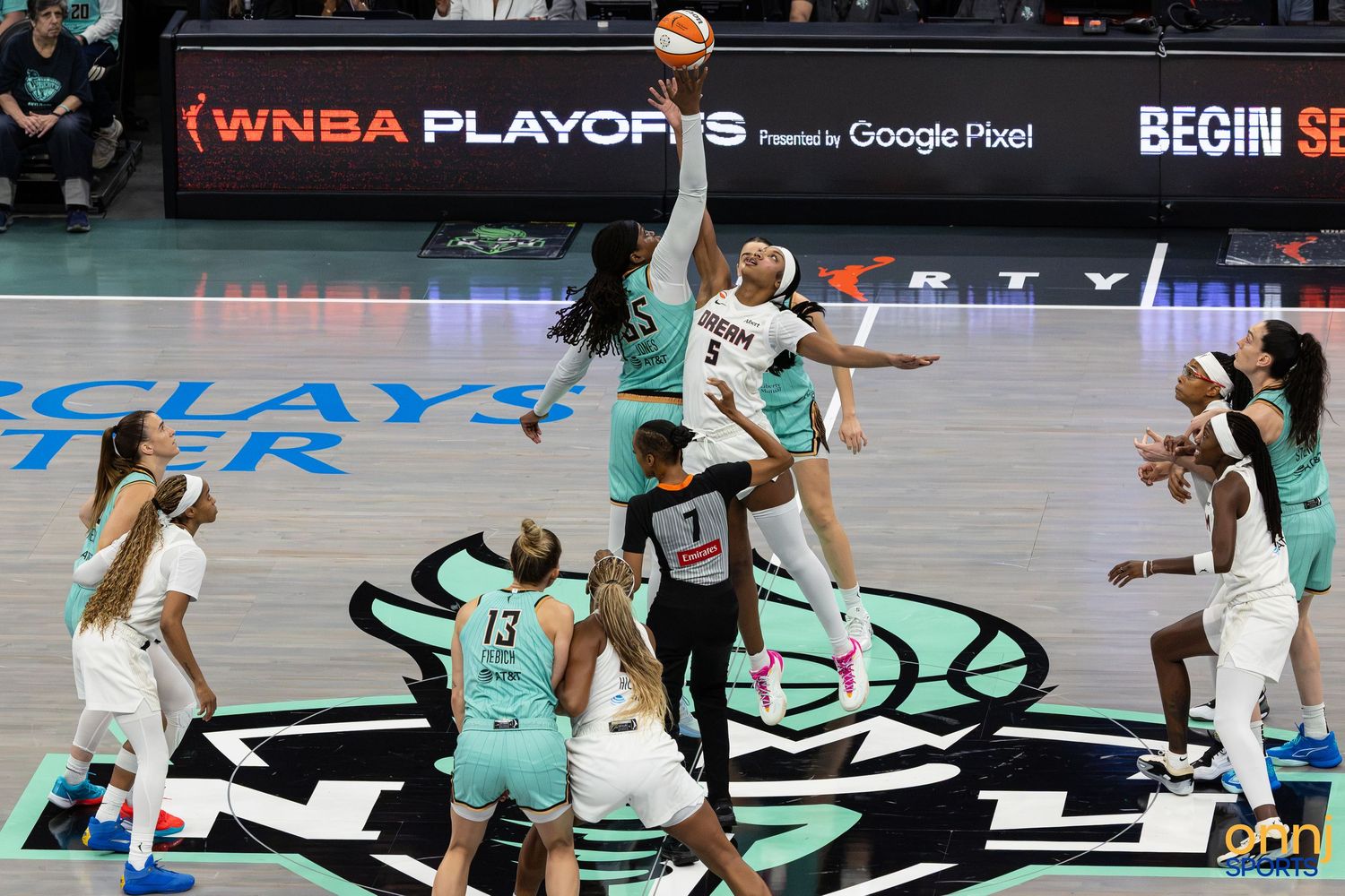 WNBA Playoffs tip-off jump ball between two teams at Barclays Center during an intense playoff game.