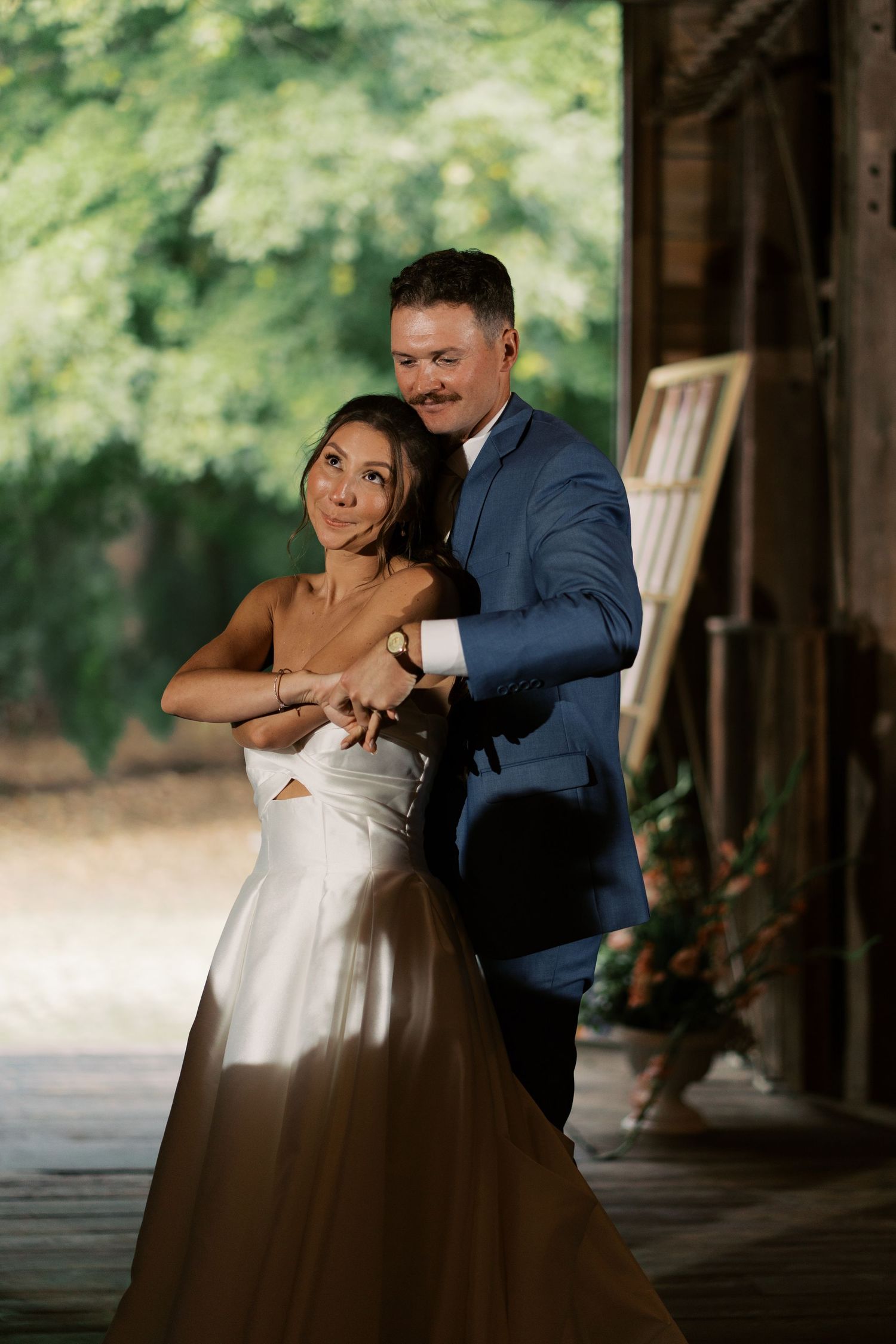 Intimate first dance under the hand-hewn beams and string lights of the Salt River Farm barn reception.