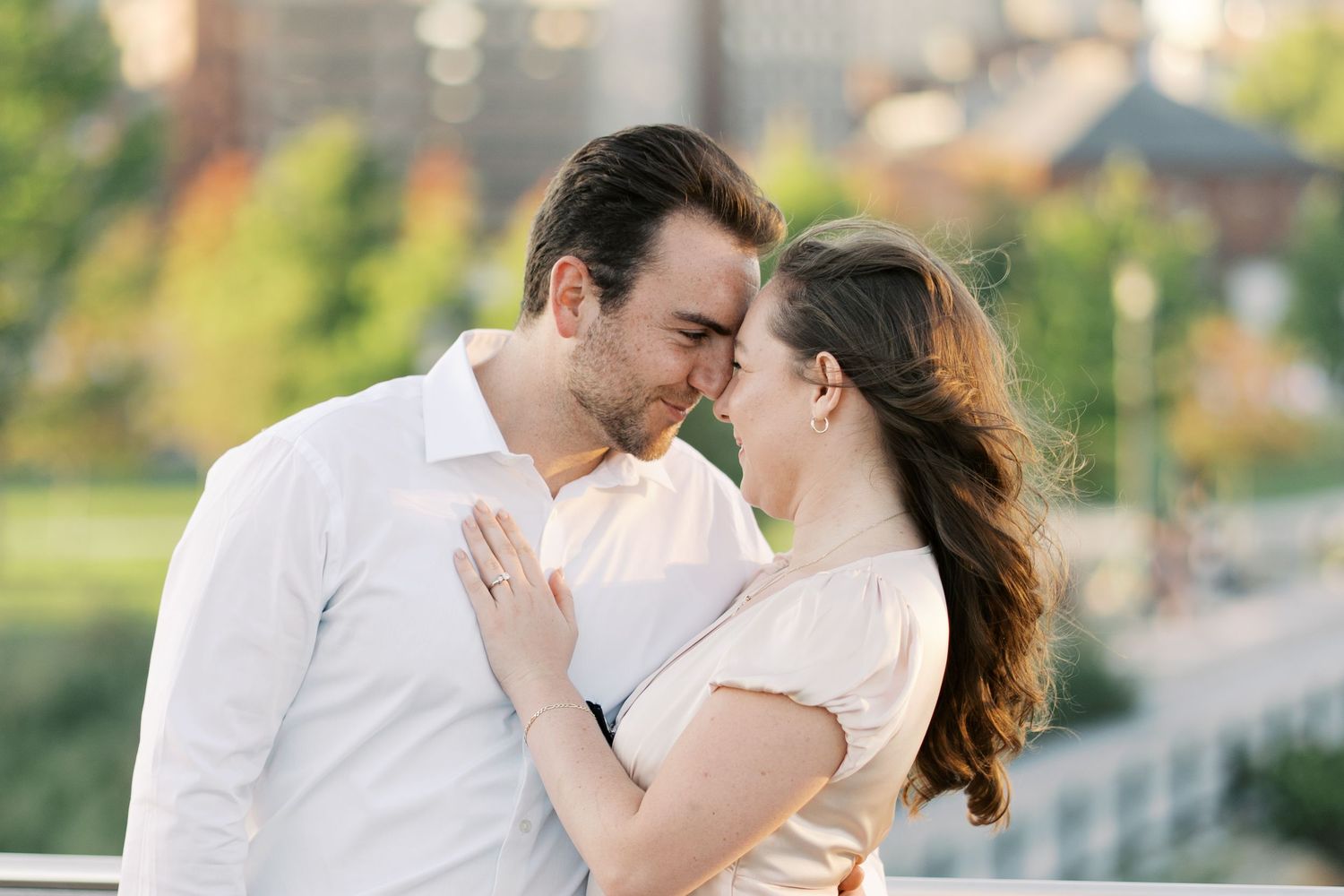 Loving couple embracing on the Michael S. Van Leesten Memorial Bridge in Providence, RI for their engagement photoshoot.