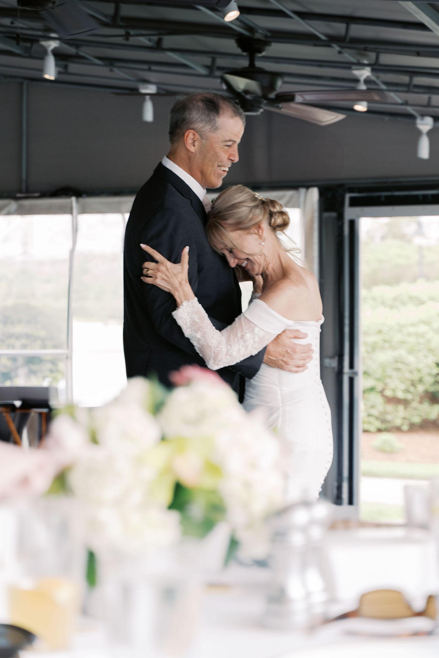 Intimate wedding photography of a couple sharing a quiet slow dance at their Tiverton, RI restaurant reception.