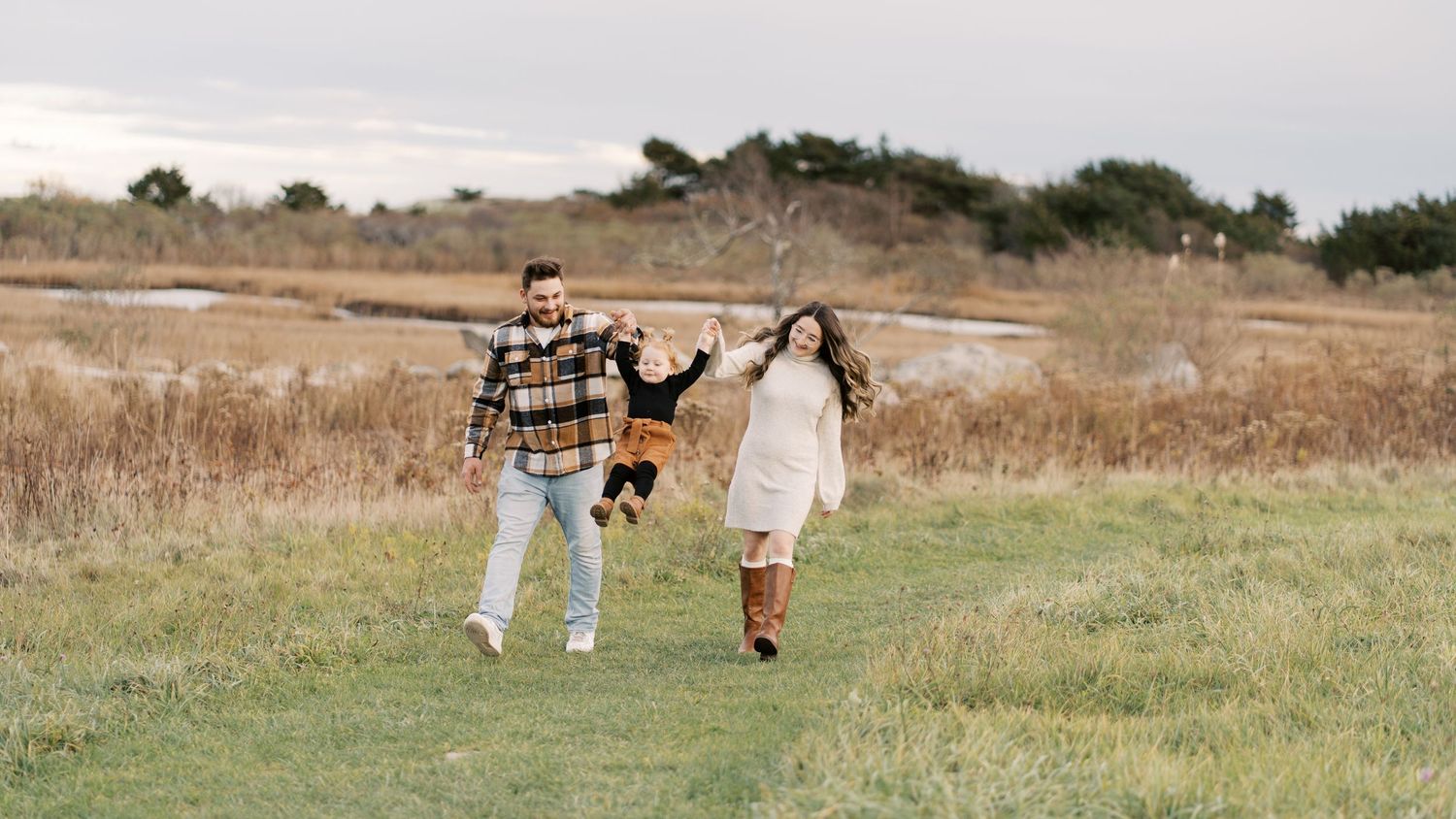 A fun shot of a couple lifting their daughter in the air. Taken at Allen's Pond in Dartmouth, MA.
