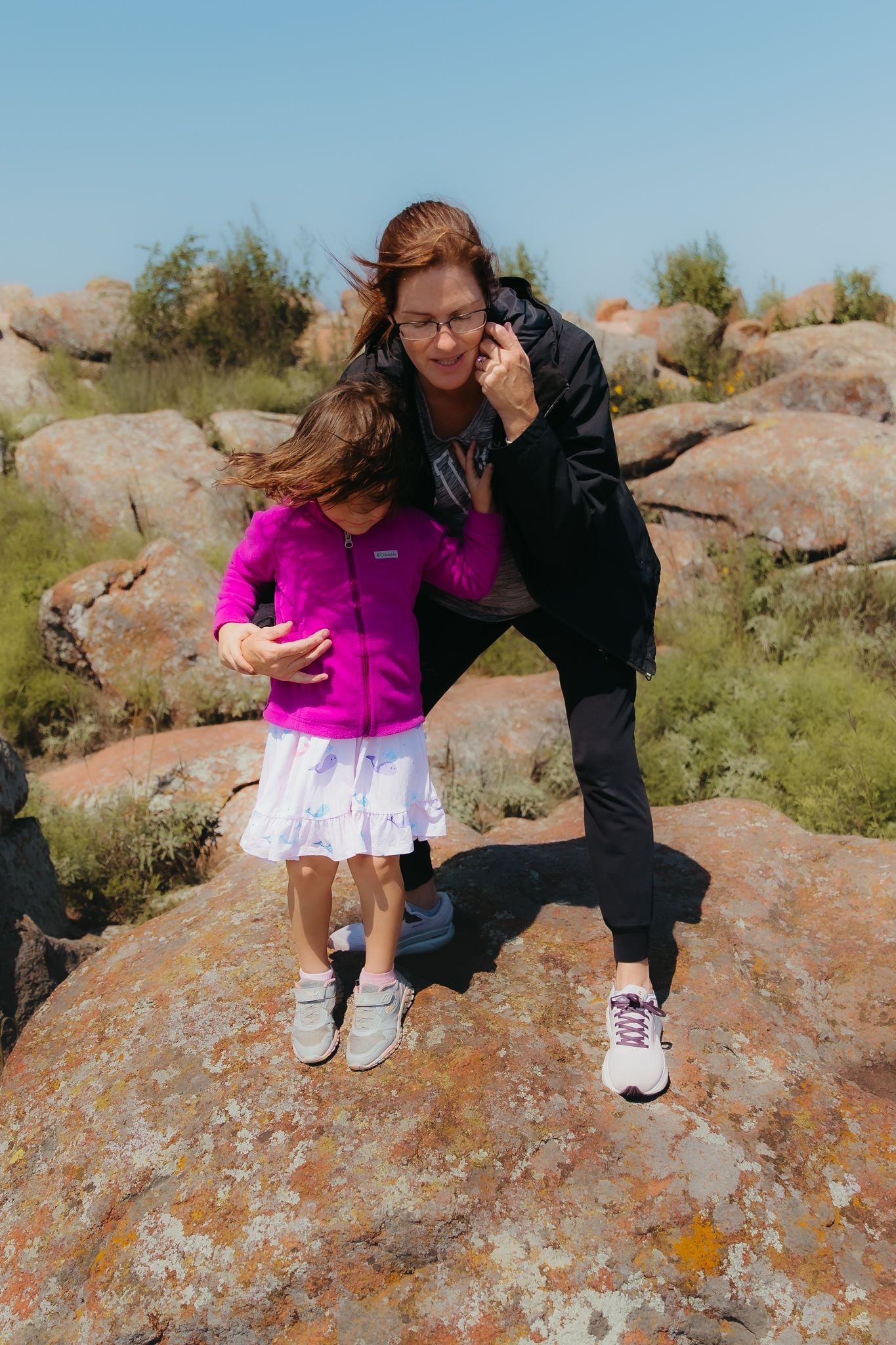 Family on large Mt. Scott rocks in sequence of candid climbing shots. In-Home Photography Liz Perez
