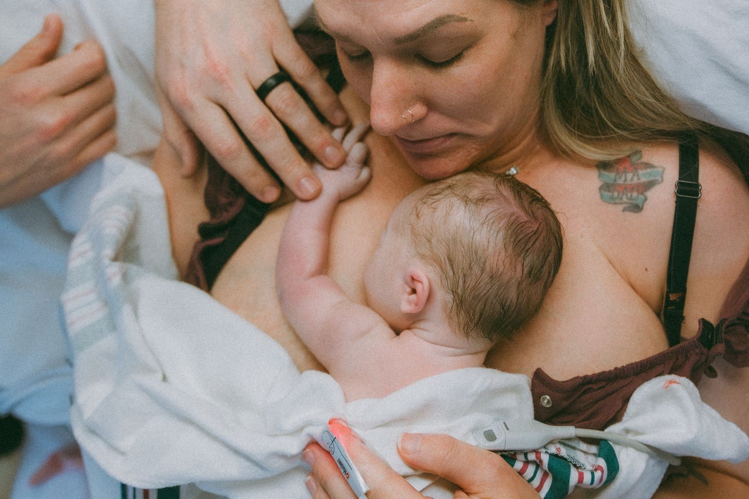 An intimate moment when mom and dad get to meet their newborn in Lawton, Oklahoma captured by Fort Still, OK  birth photographer Liz Perez.