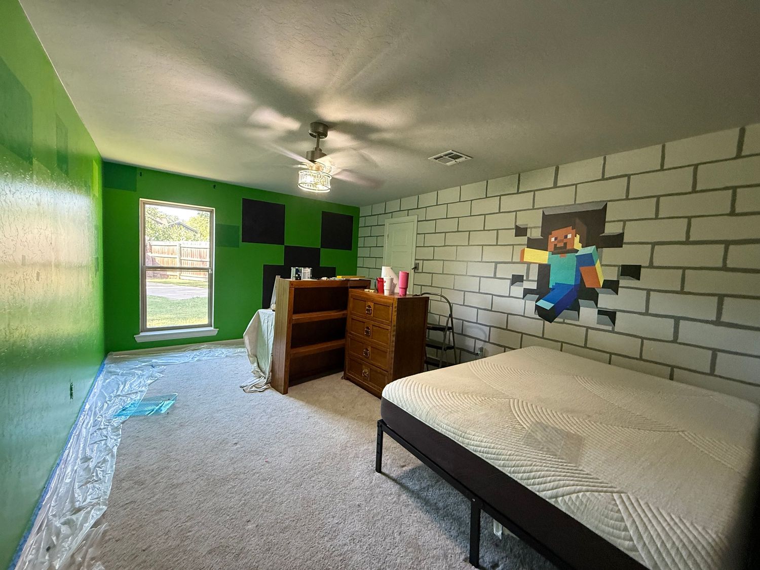 A bedroom with bright green walls, white brick pattern, and Minecraft themed decor showcases gaming-inspired interior design. In-Home Photog