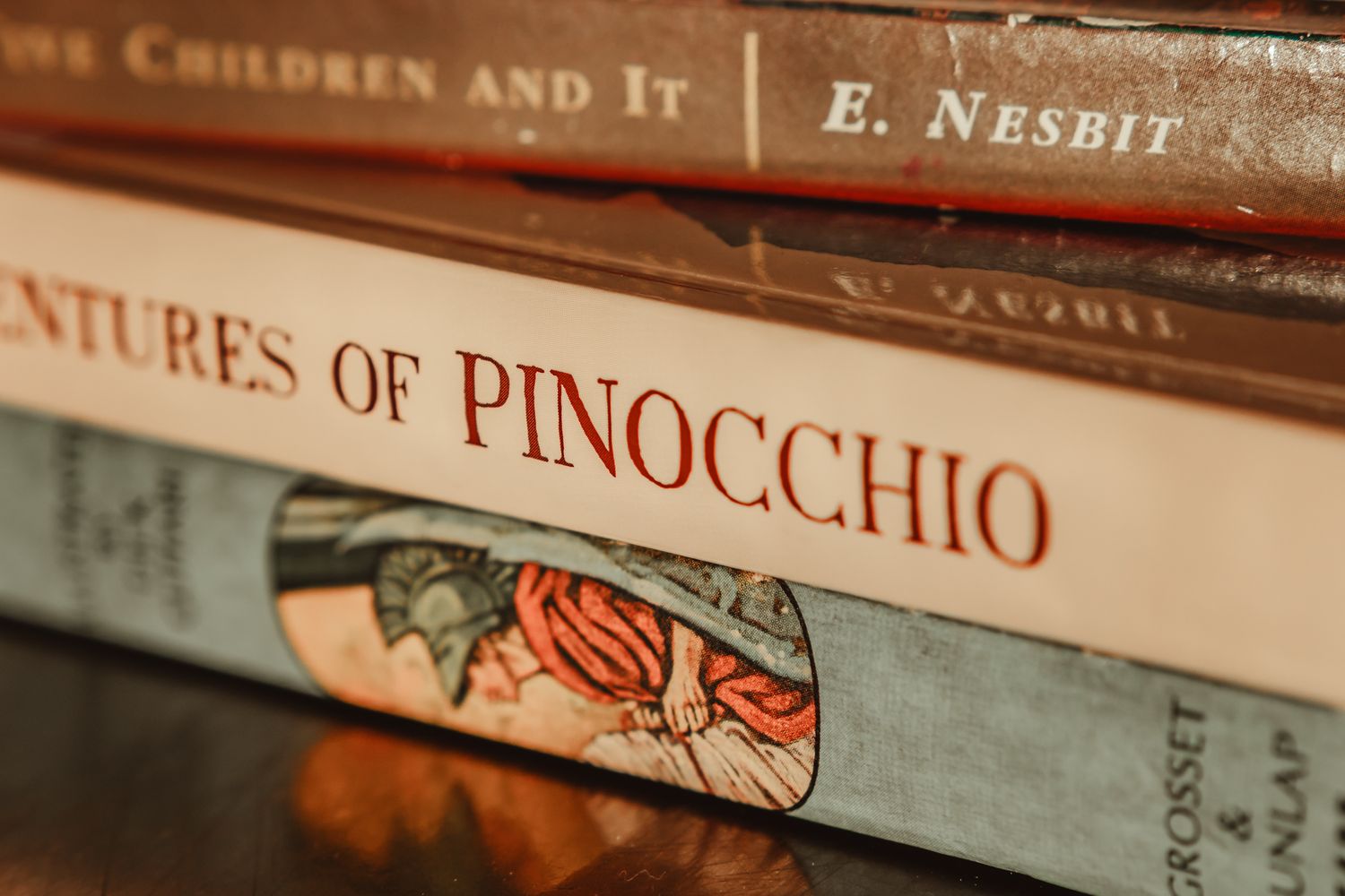 Close-up view of vintage children's books including The Adventures of Pinocchio on a shelf.