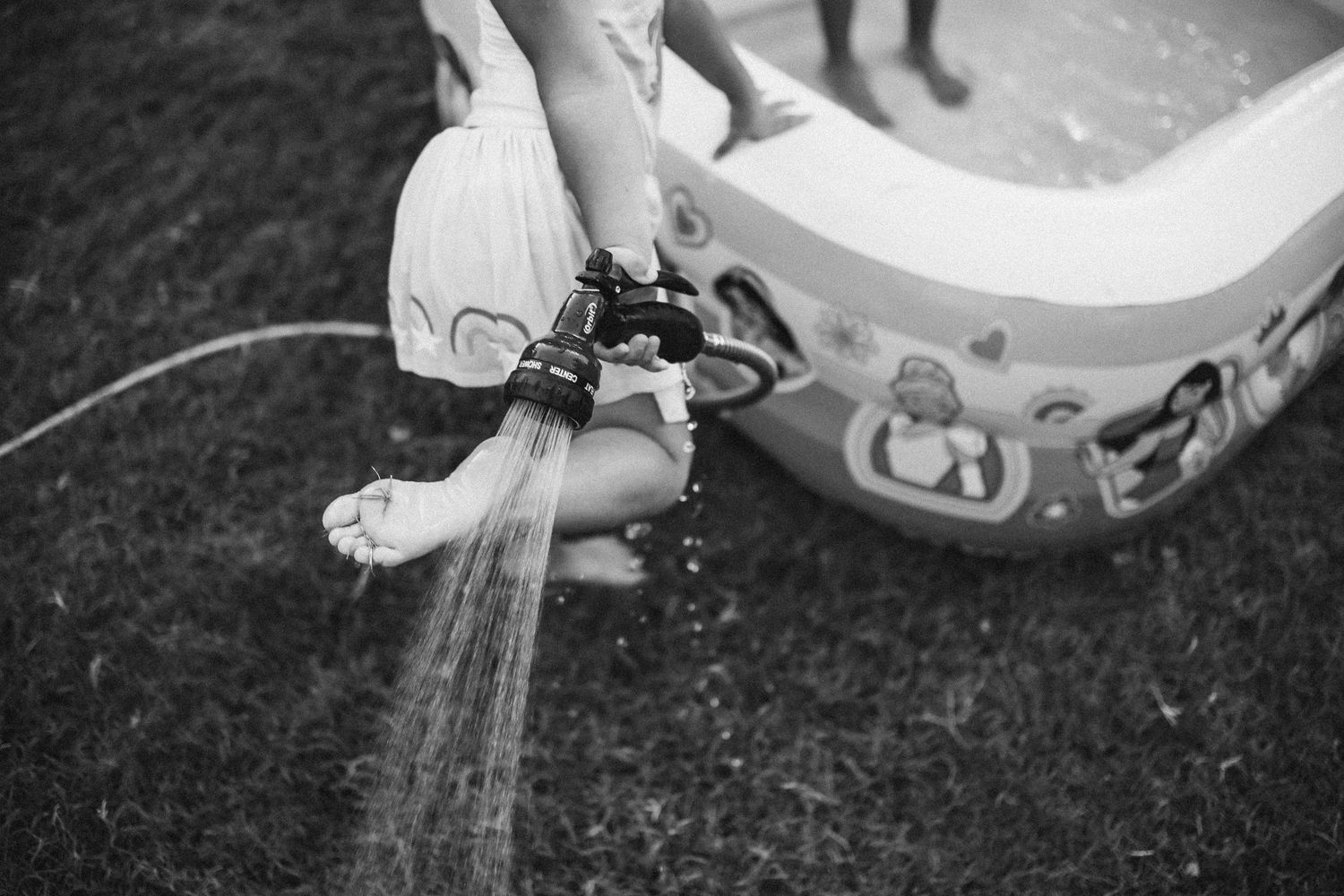 Various detailed close-up shots of kids washed and cleaned with spraying water and scrubbing brushes. In-Home Photography Liz Perez