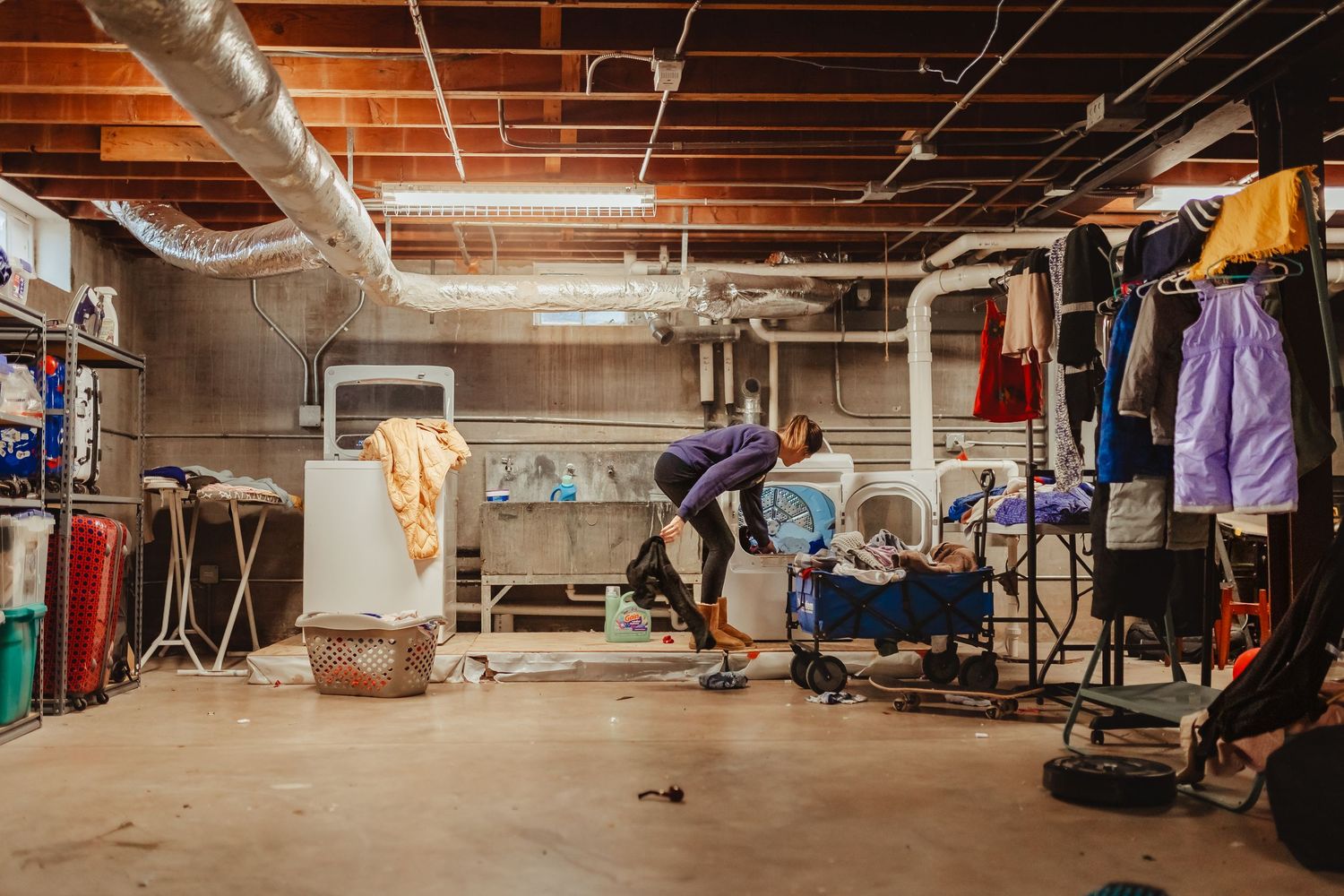 Wide panoramic view of an empty industrial basement or storage space with exposed ceiling.