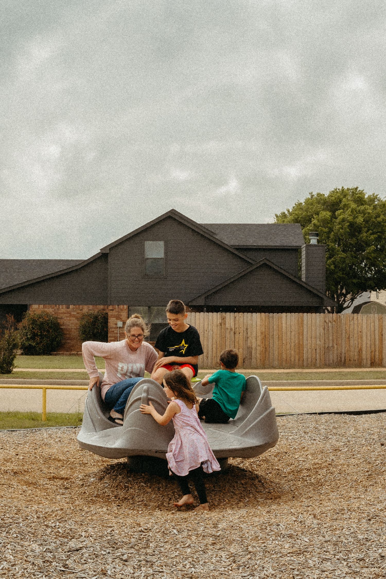 Lawton, Oklahoma Documentary family photographer Liz Perez in the frame with kids at the park by using the interval timer on the DSLR.