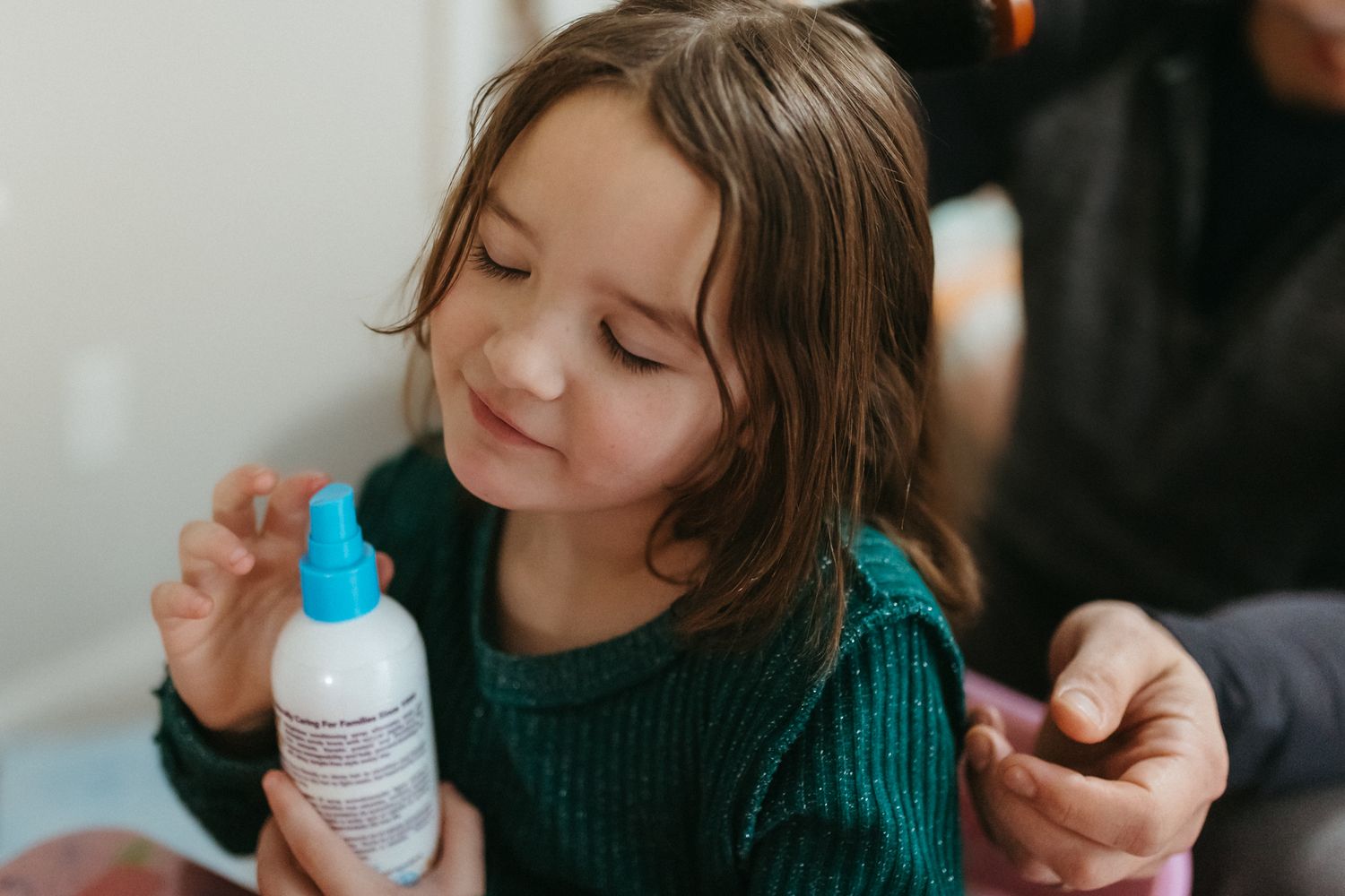 Close-up view of gentle hair care activities in a domestic setting.
