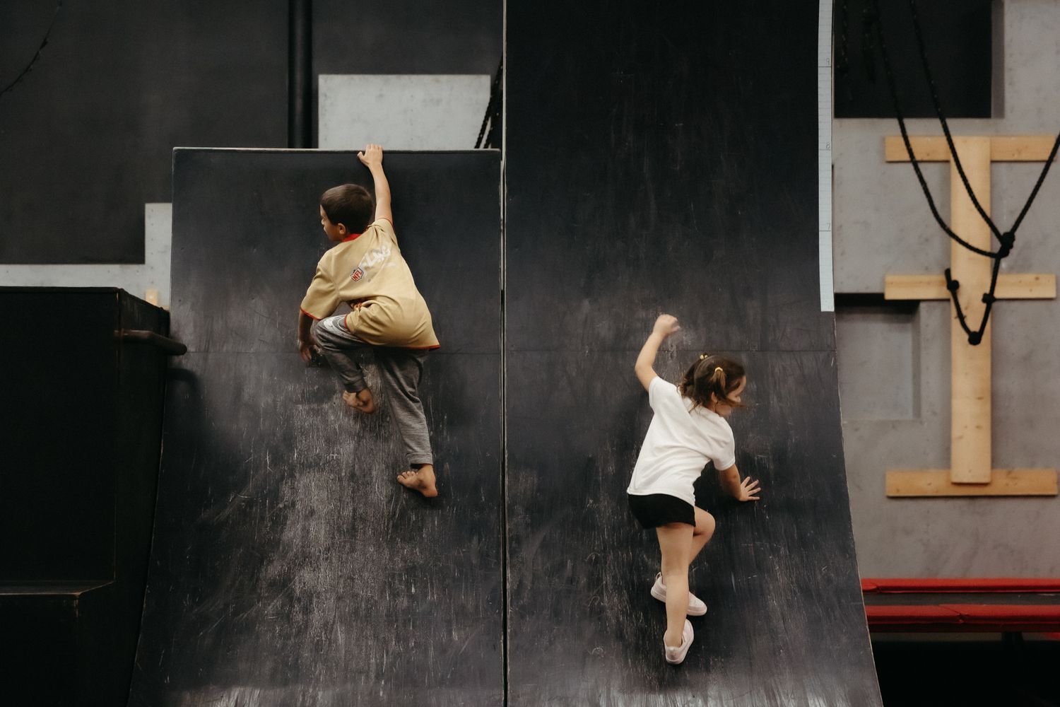 A dynamic sequence showing parkour movements on a dark wall.
