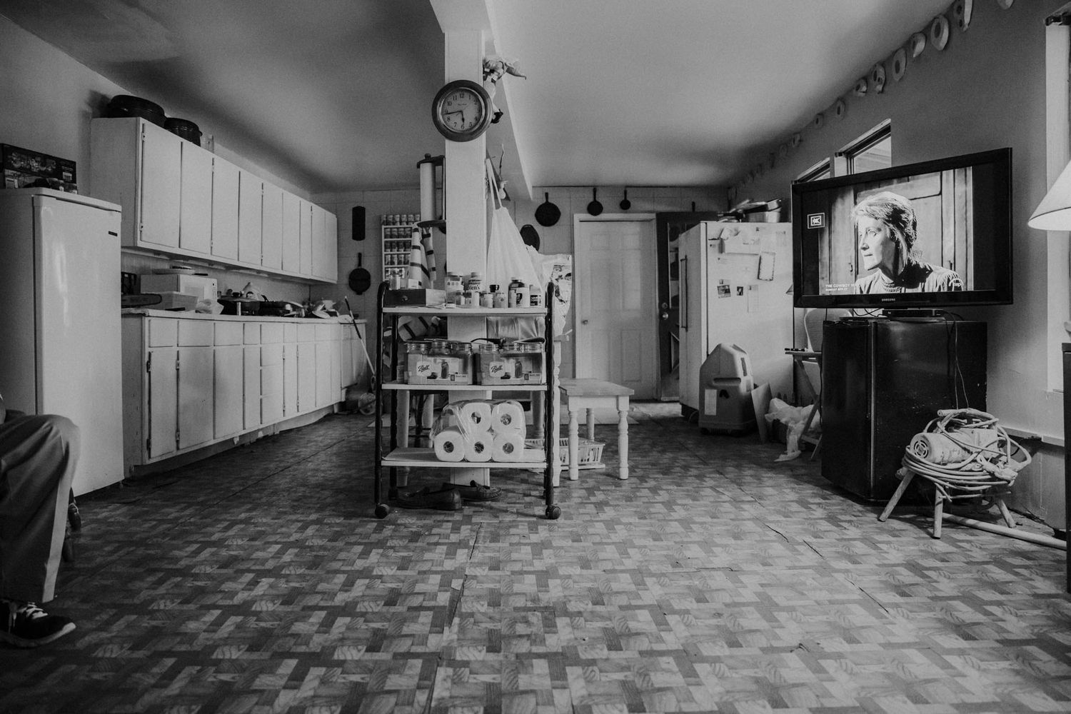 Black and white view of a vintage kitchen interior with checkered floor.