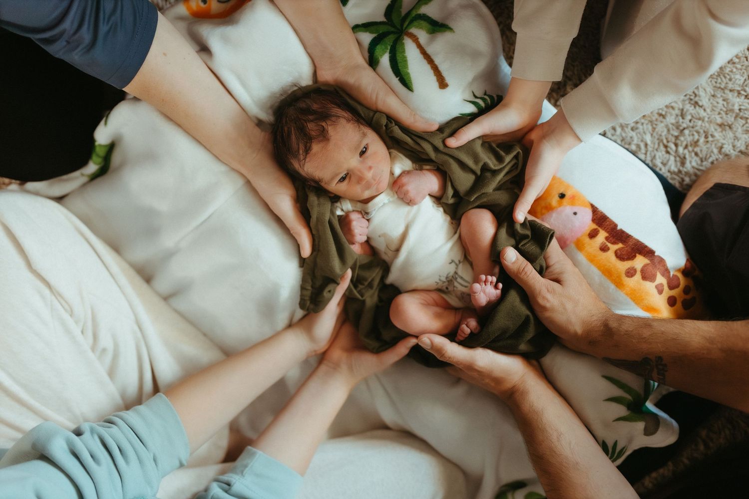 Family members sharing snacks while relaxing together on a carpeted floor.