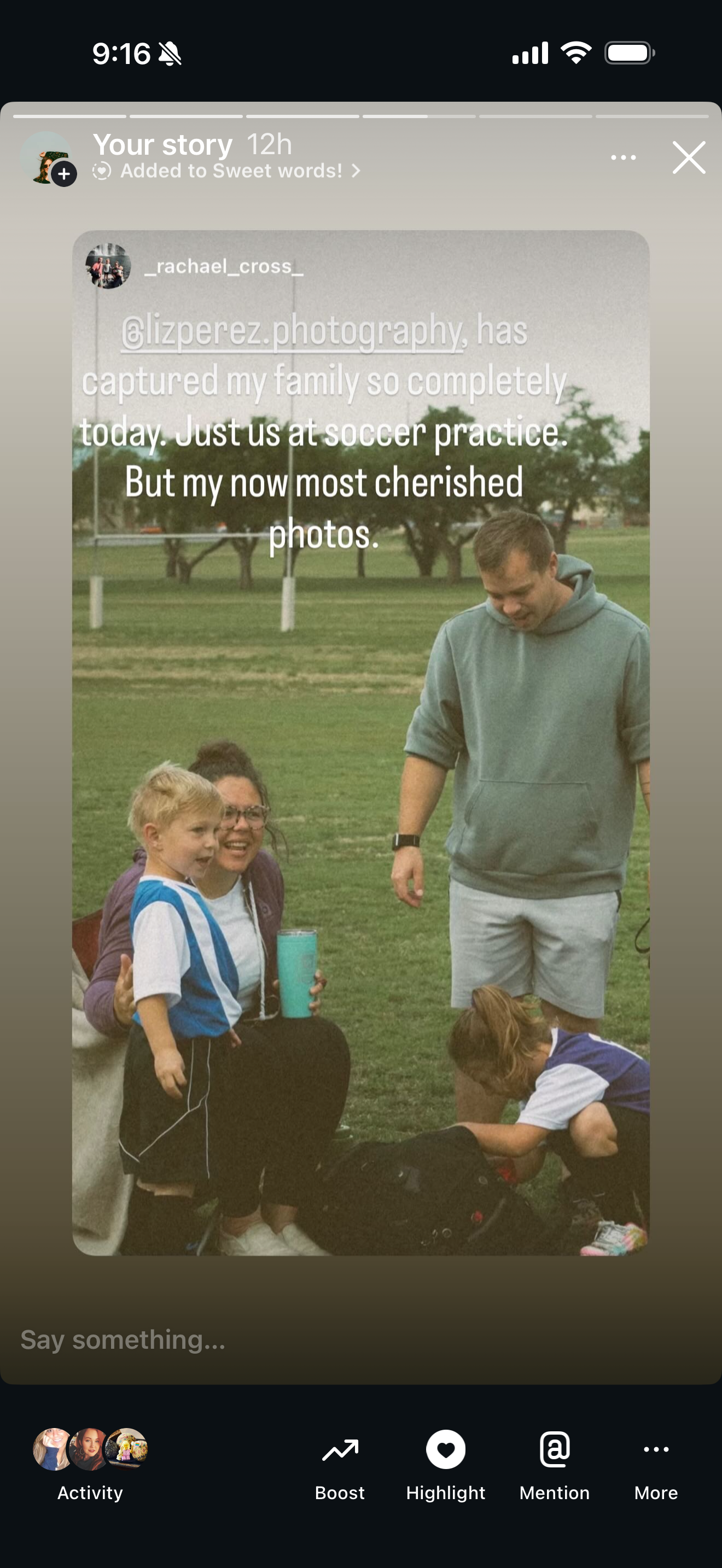 Family at soccer practice captured candidly, with children and parents on a green field in casual outdoor clothing.