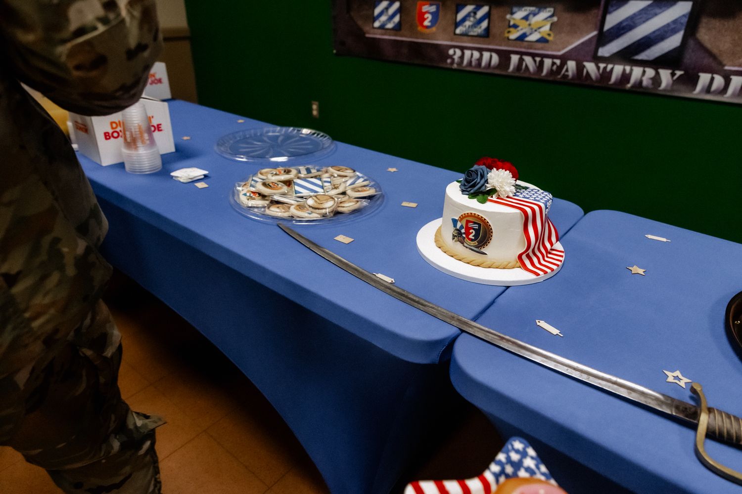 A patriotic holiday table setting with red white and blue decorations and American flags.