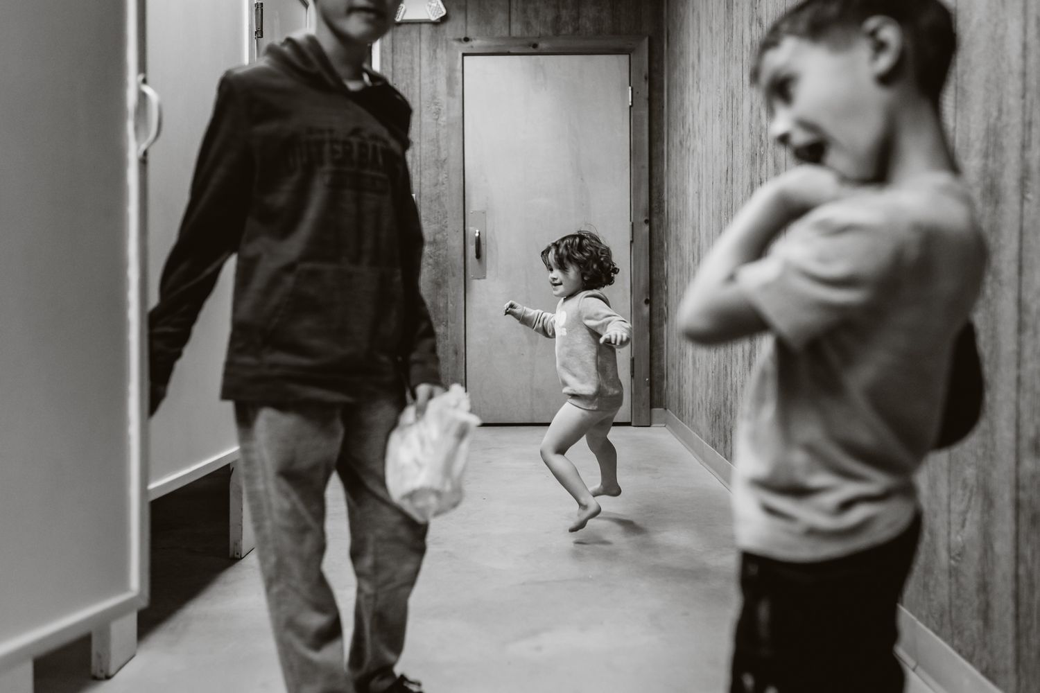 Black and white sequence of movement along a hallway or corridor.