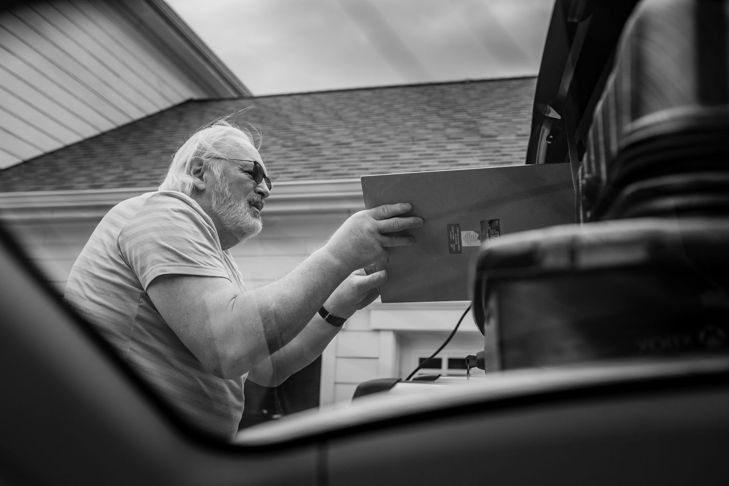 Person loading a car. In-Home Photography Liz Perez