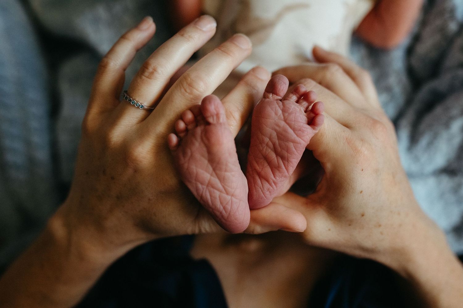 Close-up details of gentle hands holding in an intimate moment.