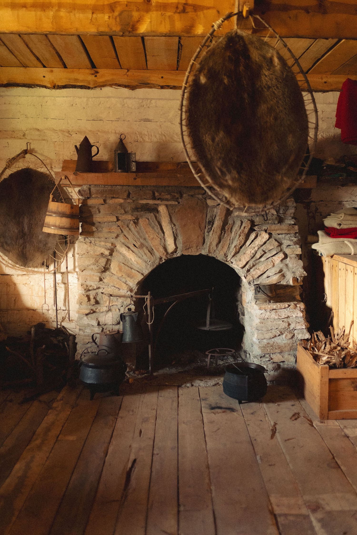 Historic stone fireplaces with arched openings and rustic wooden flooring line a wall in an old building. Lawton, Ok Photography Liz Perez