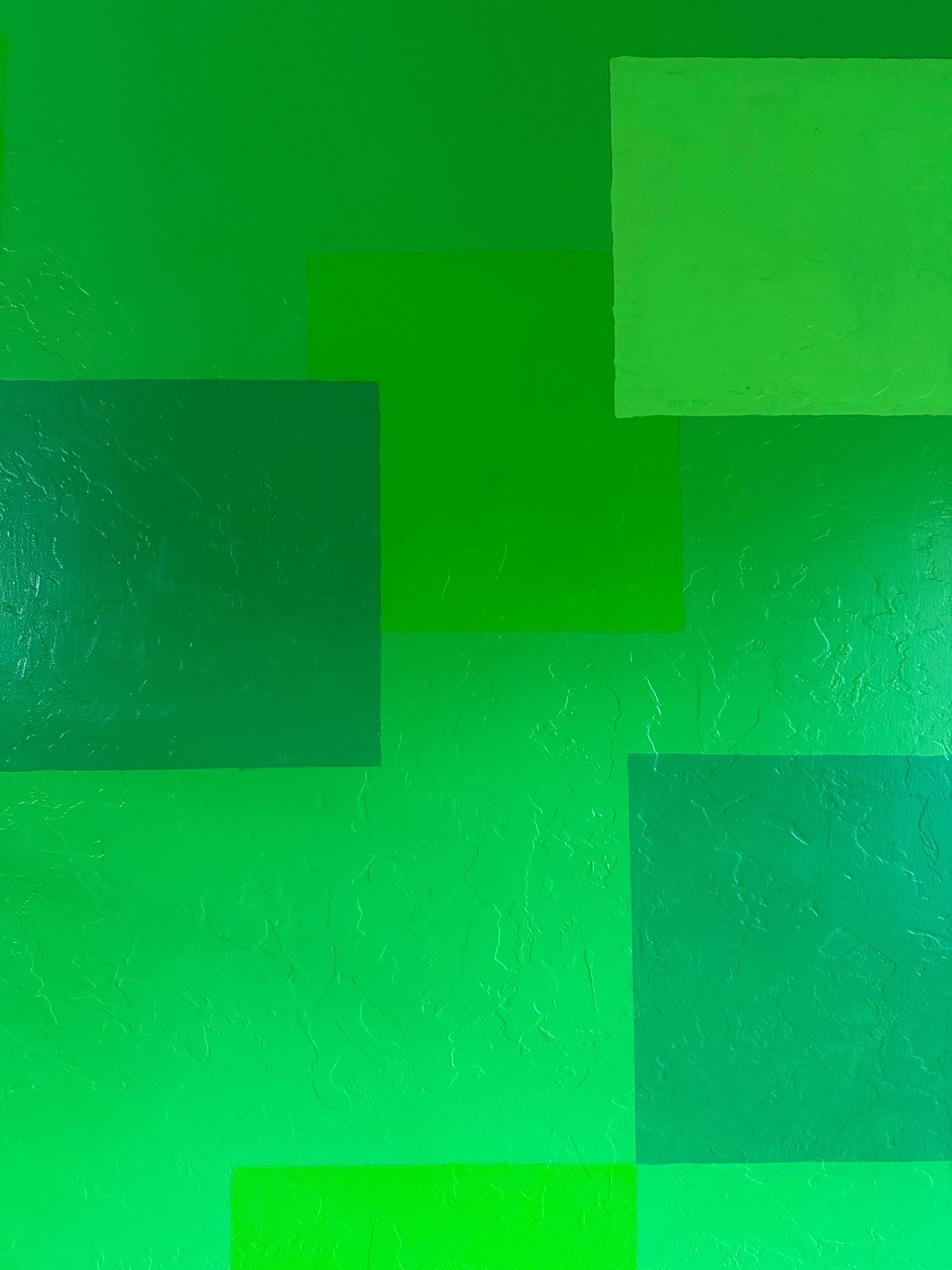 Geometric pattern of overlapping rectangles in vibrant green tones creating a modern abstract design. In-Home Photography Liz Perez