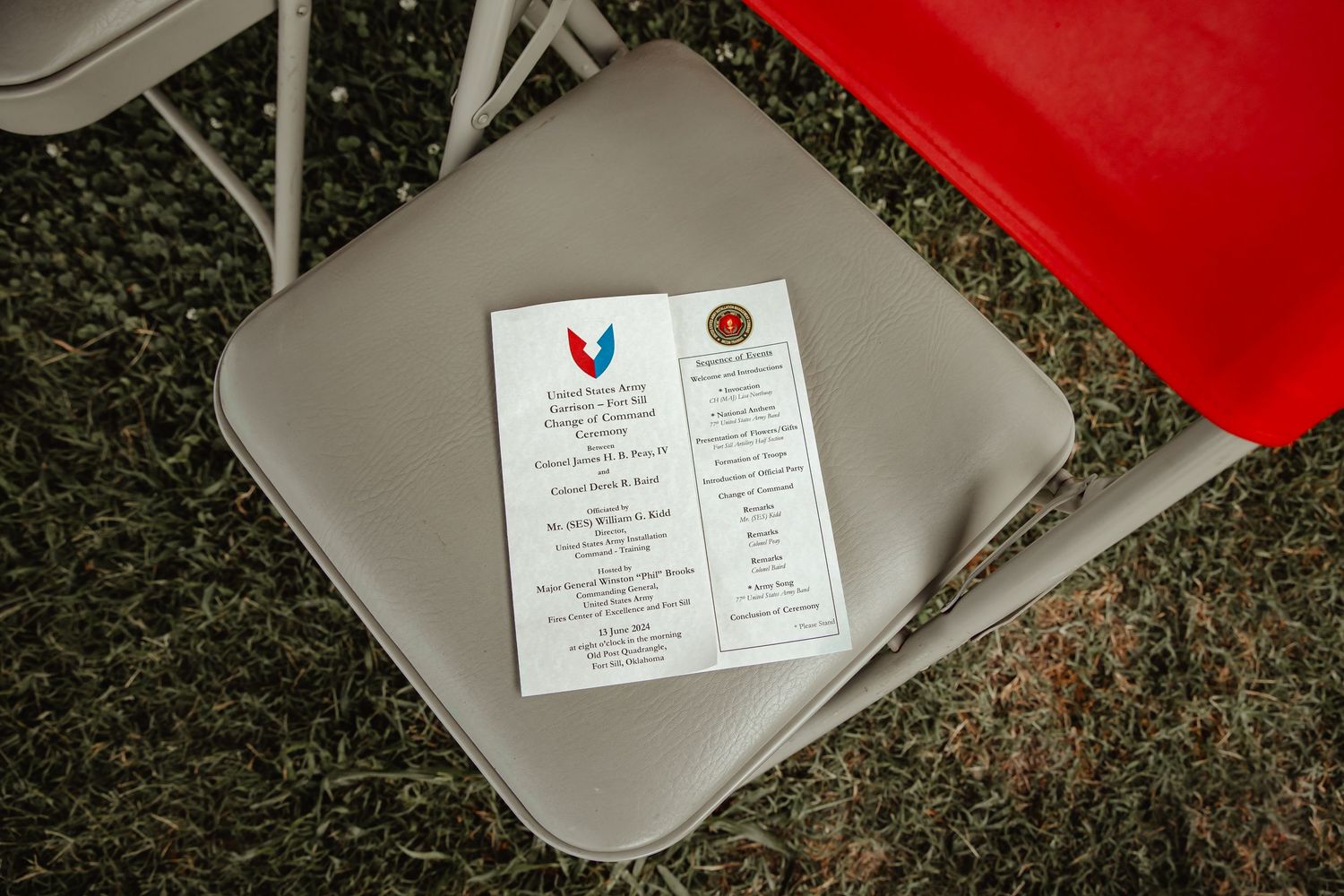 A series of business cards and documents arranged on a gray and red background showing professional branding materials.