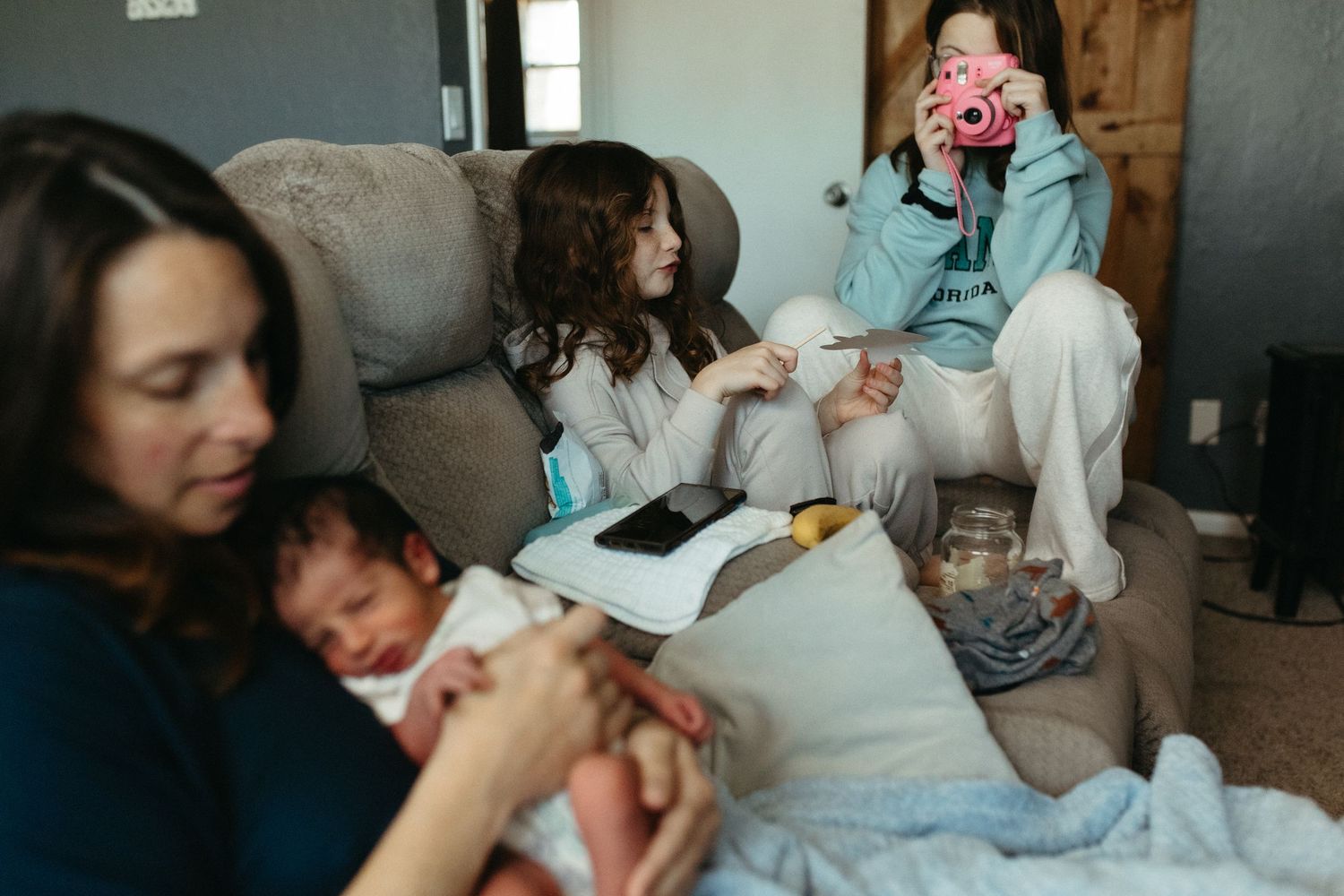 Candid family moments captured in a cozy living room setting.