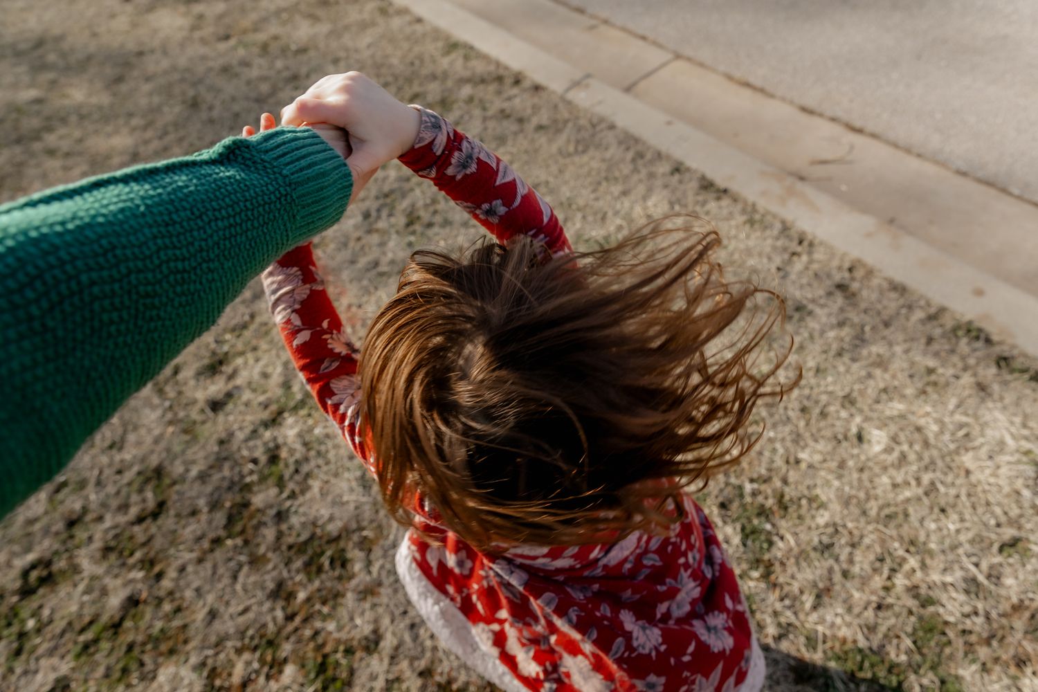 How to be in the frame creatively with documentary family photographer of Lawton, Oklahoma Liz Perez with a child spinning off her arm.