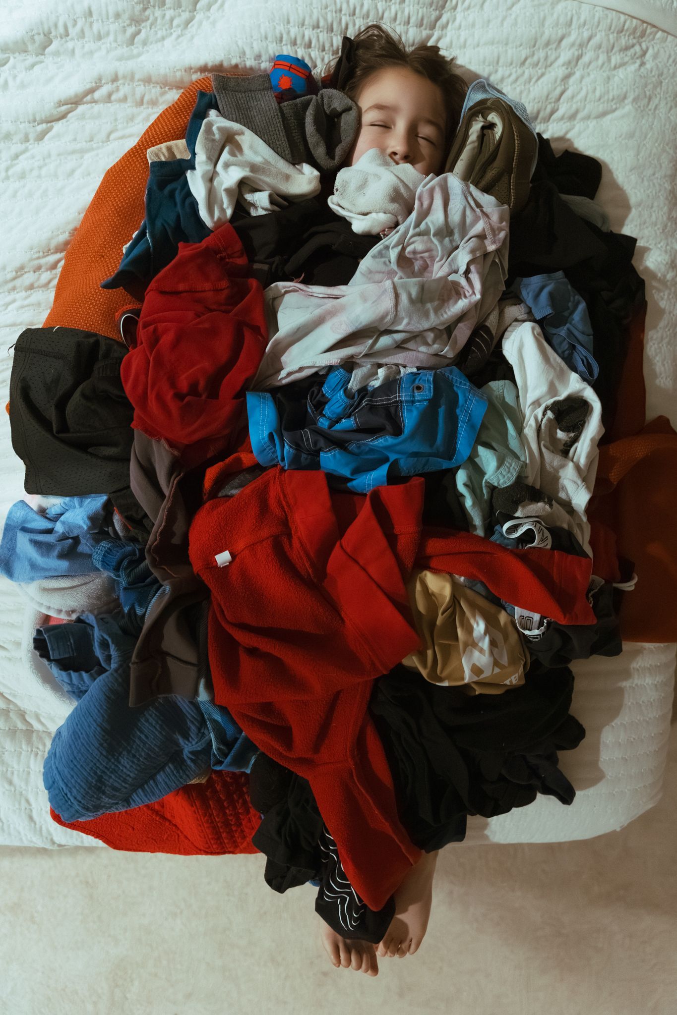 Sequence showing a messy pile of laundry with red, blue, and black clothing items.