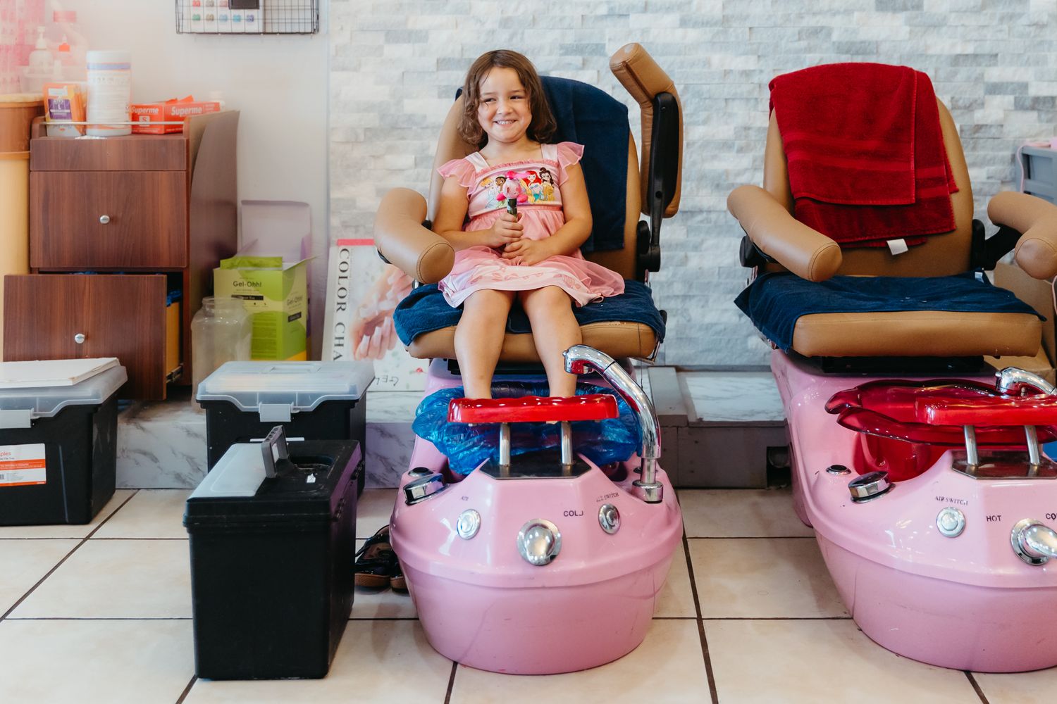 A series of pink inflatable chairs or ottomans shown from different angles in a living room setting.