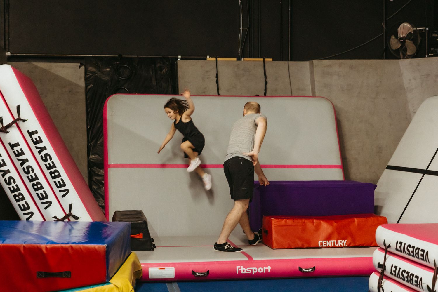 A series of gymnastic movements captured on red and white training equipment.