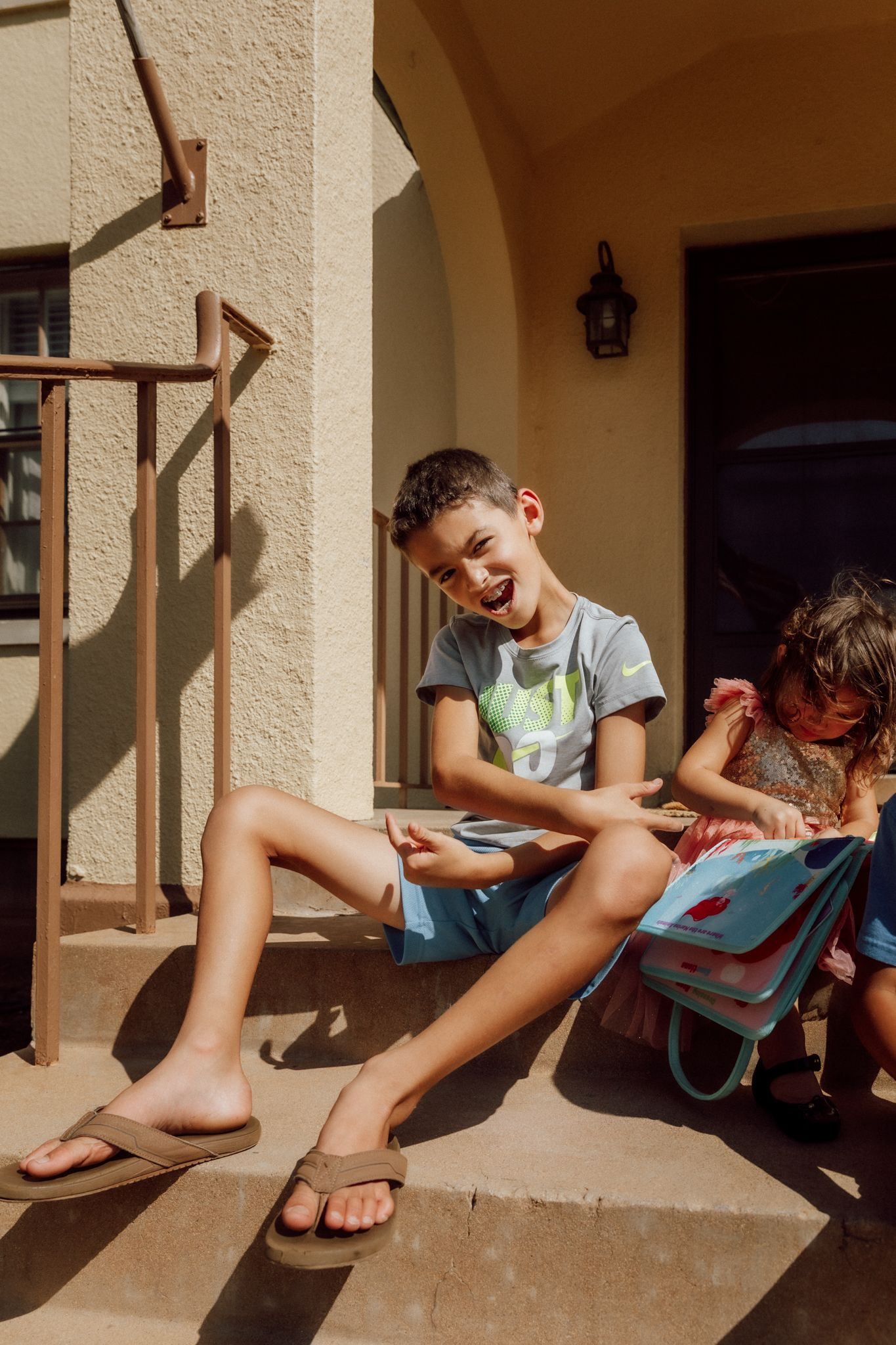 Child sits on a porch step in sunlight creating playful shadows in a multi-panel sequence of summer moments.