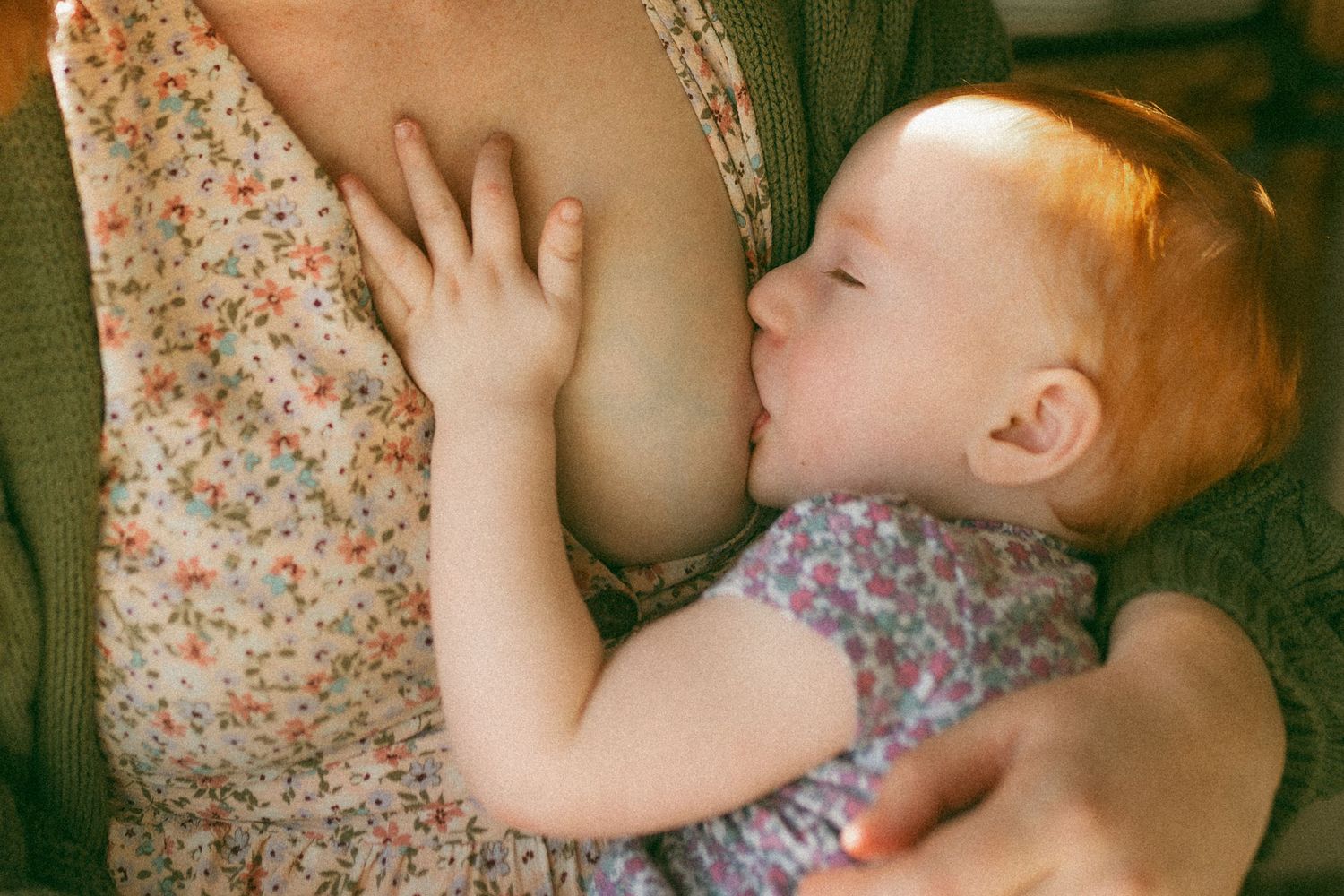 A series of four connected photos showing a baby sleeping peacefully in a floral print outfit.