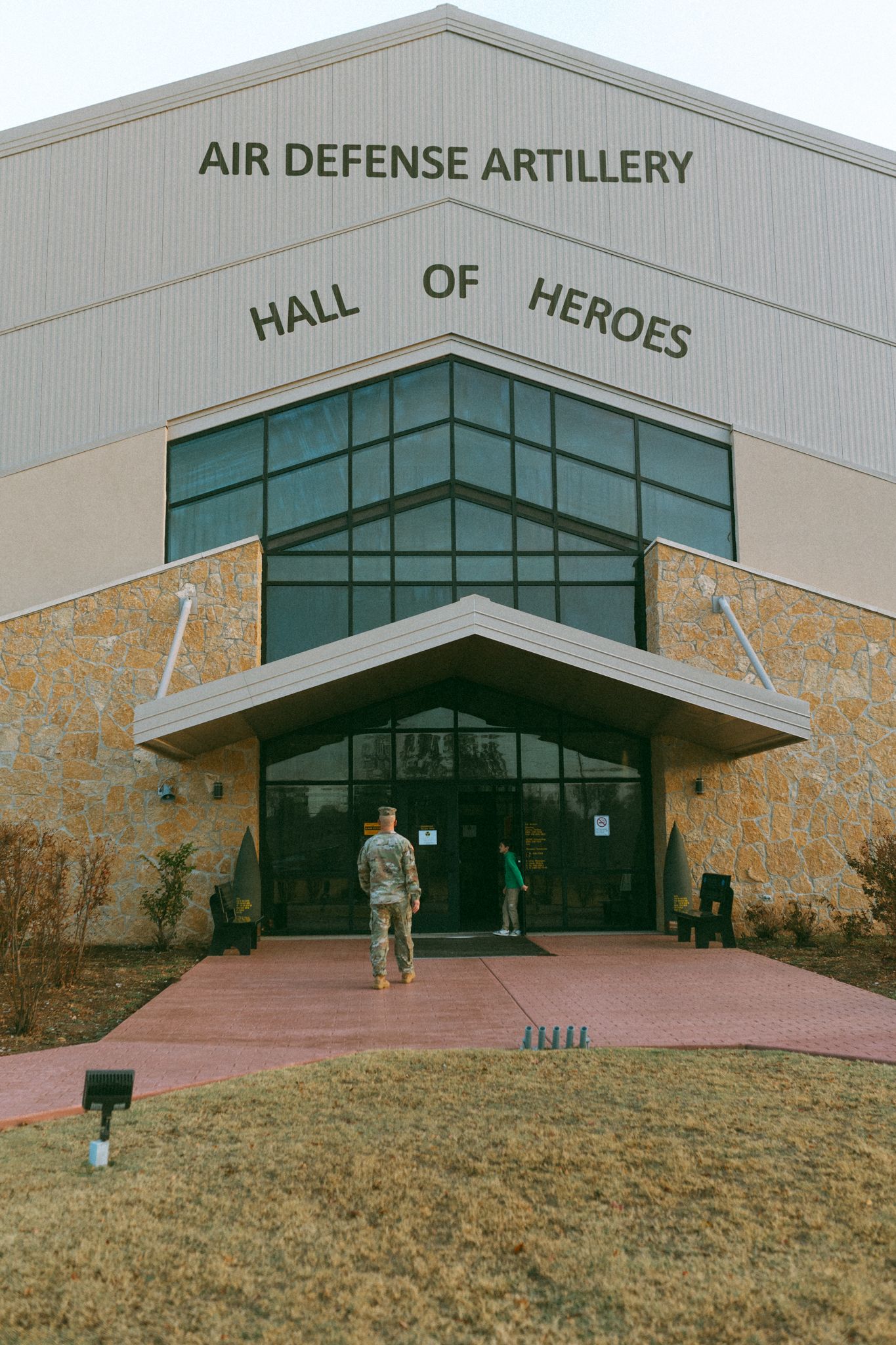 Exterior view of the Air Defense Artillery Hall of Heroes building with glass facade and signage.