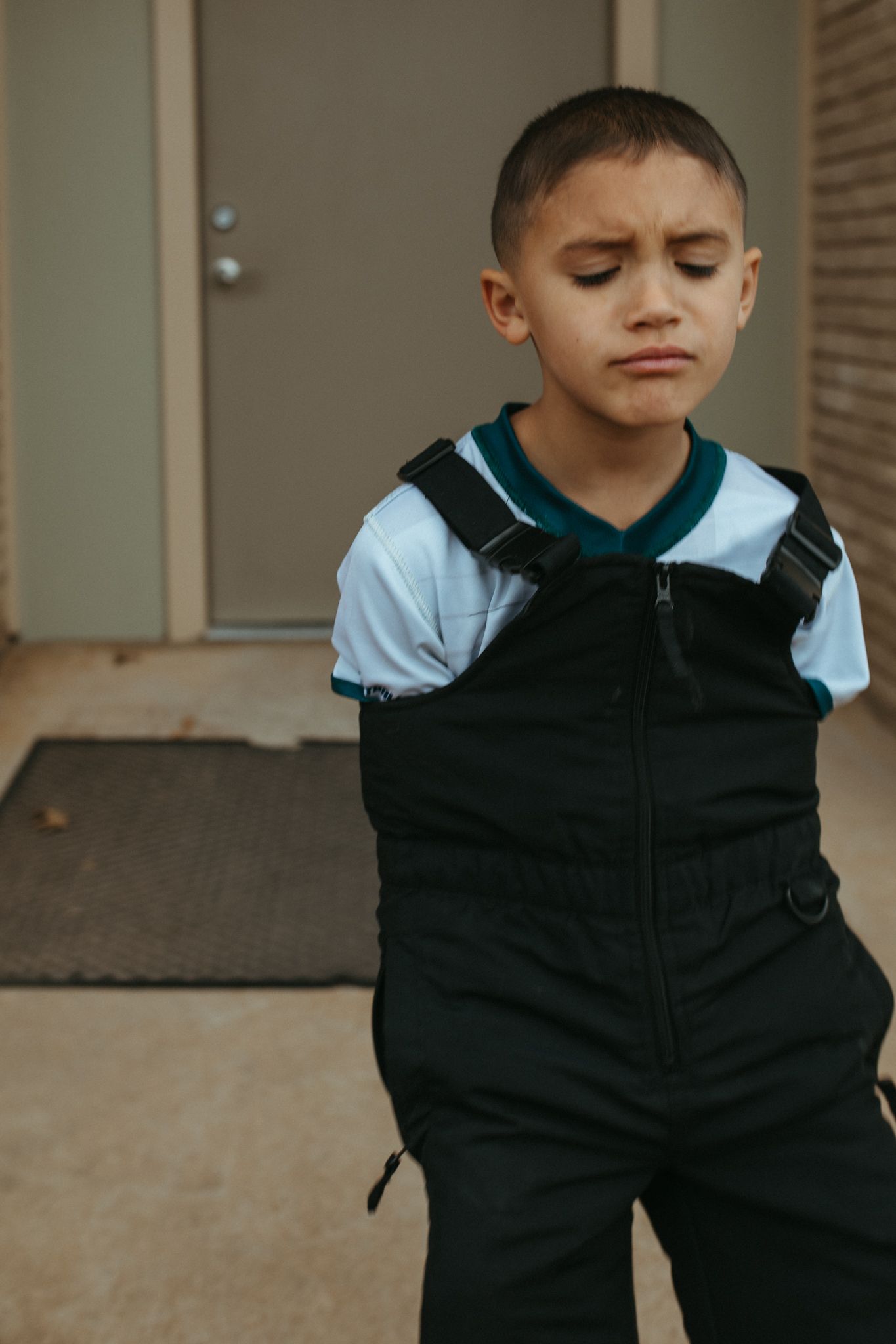 Sequence showing someone wearing a black zip-up jacket against a neutral background.