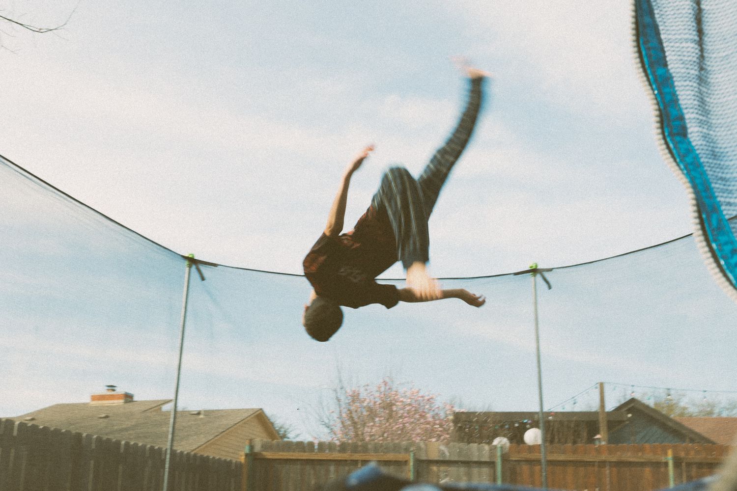 A kid doing tricks on the trampoline in Lawton,Oklahoma for family photography session with Liz Perez Photography
