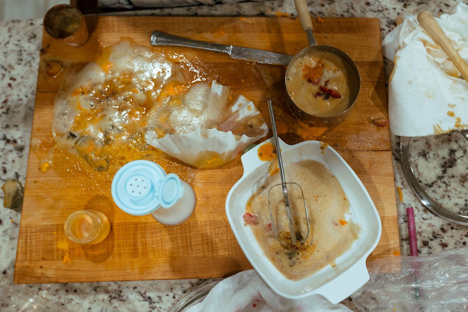 A rustic wooden kitchen counter with coffee mugs and spattered paint marks showing signs of wear and use. In-Home Photography Liz Perez