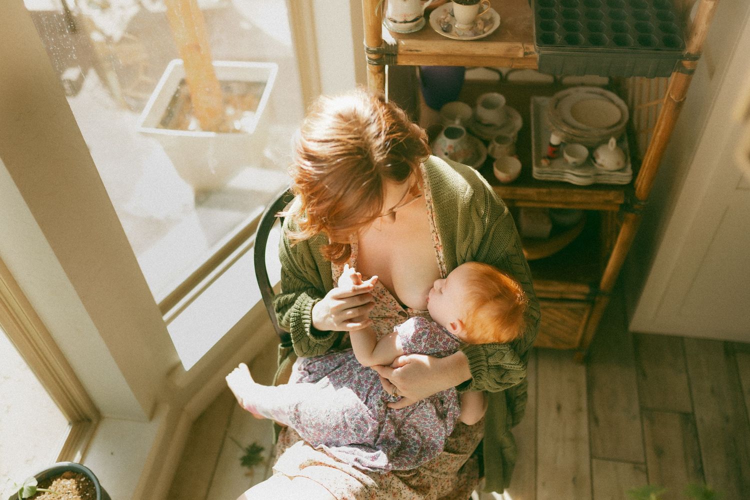 A mother nursing her daughter in home.